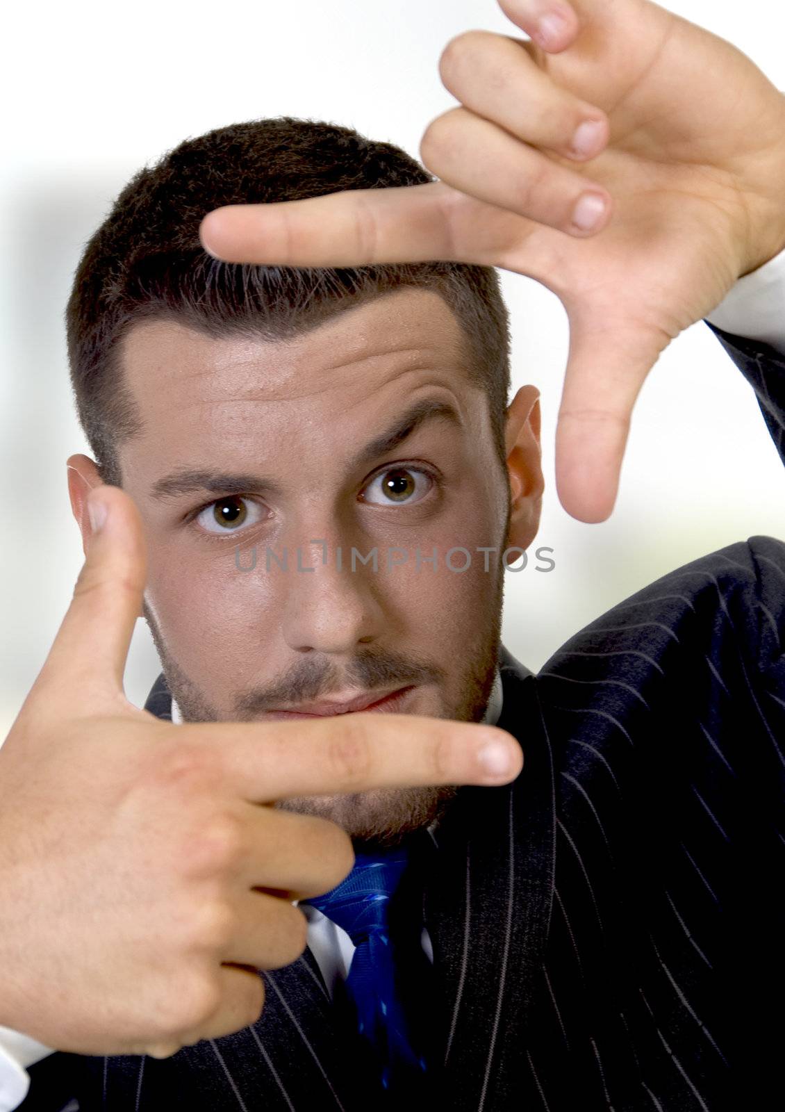 young businessman making a finger frame on an abstract  background