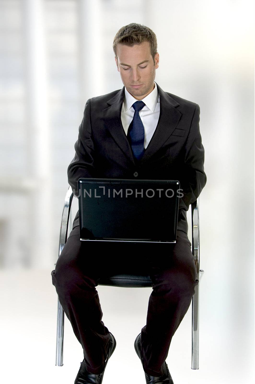 successful businessman working on laptop on an abstract  background