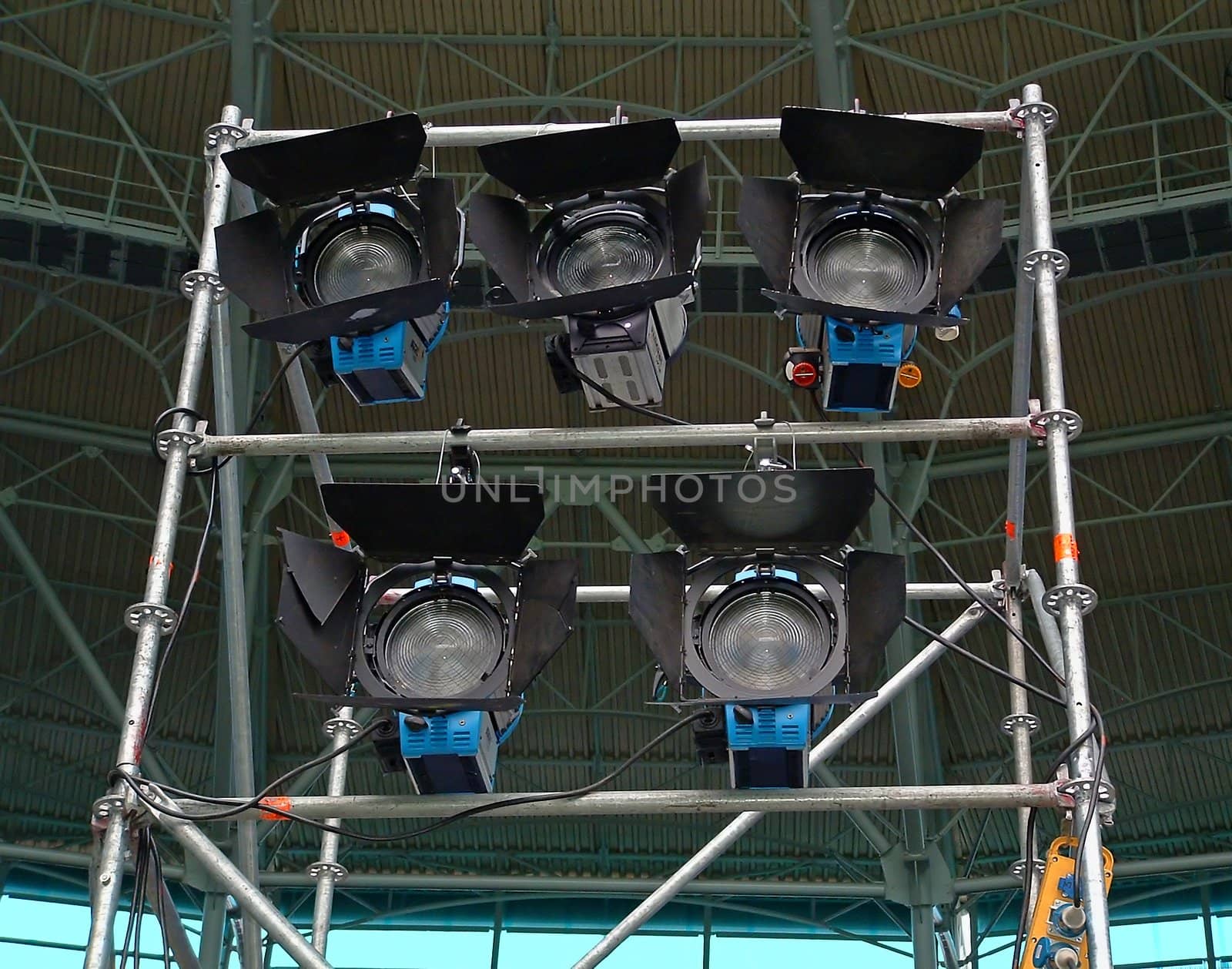 The light rack from five lanterns ready for work under a roof of arena