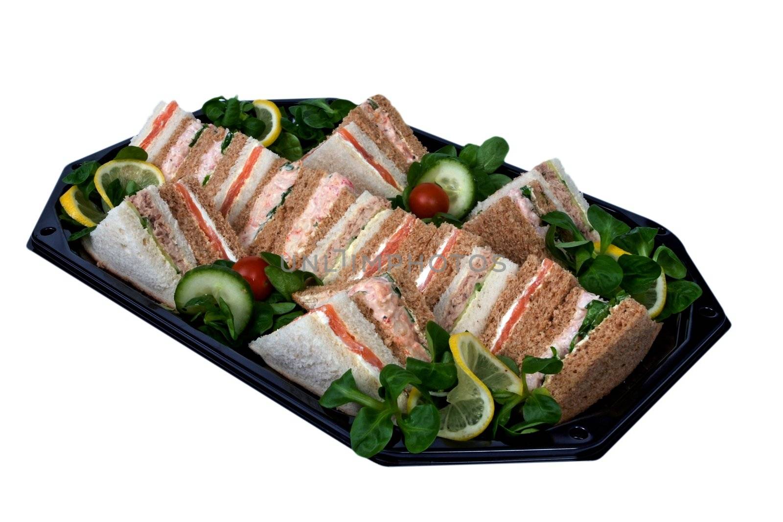 Platter of sandwiches cut into triangles, prepared on a tray for a business lunch