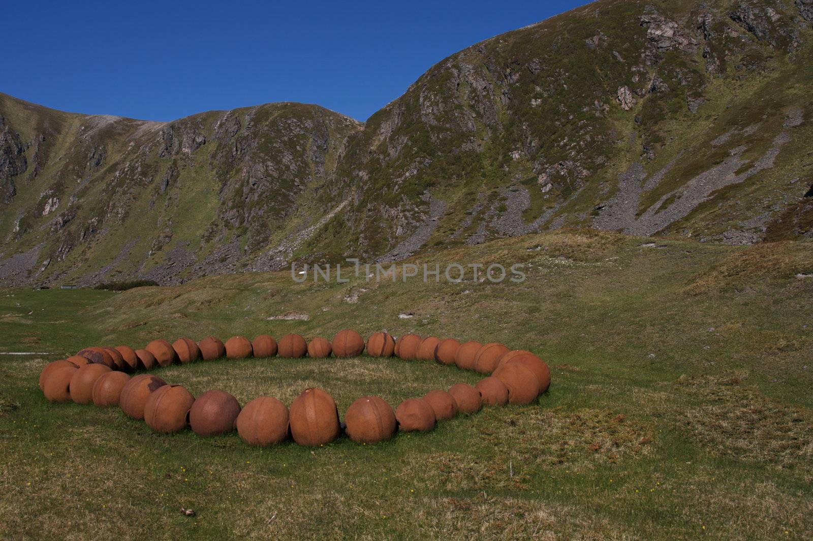 Numerous rusted spheres making a giant necklace. Taken on Andøya, Norway.