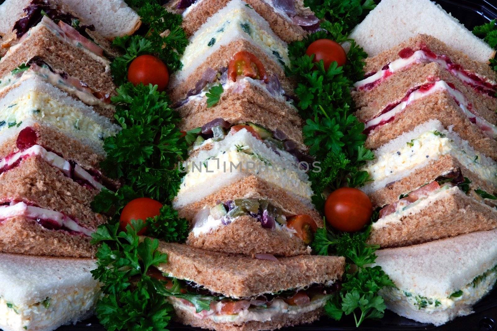 Sandwiches cut into triangles on a tray prepared for a business lunch
