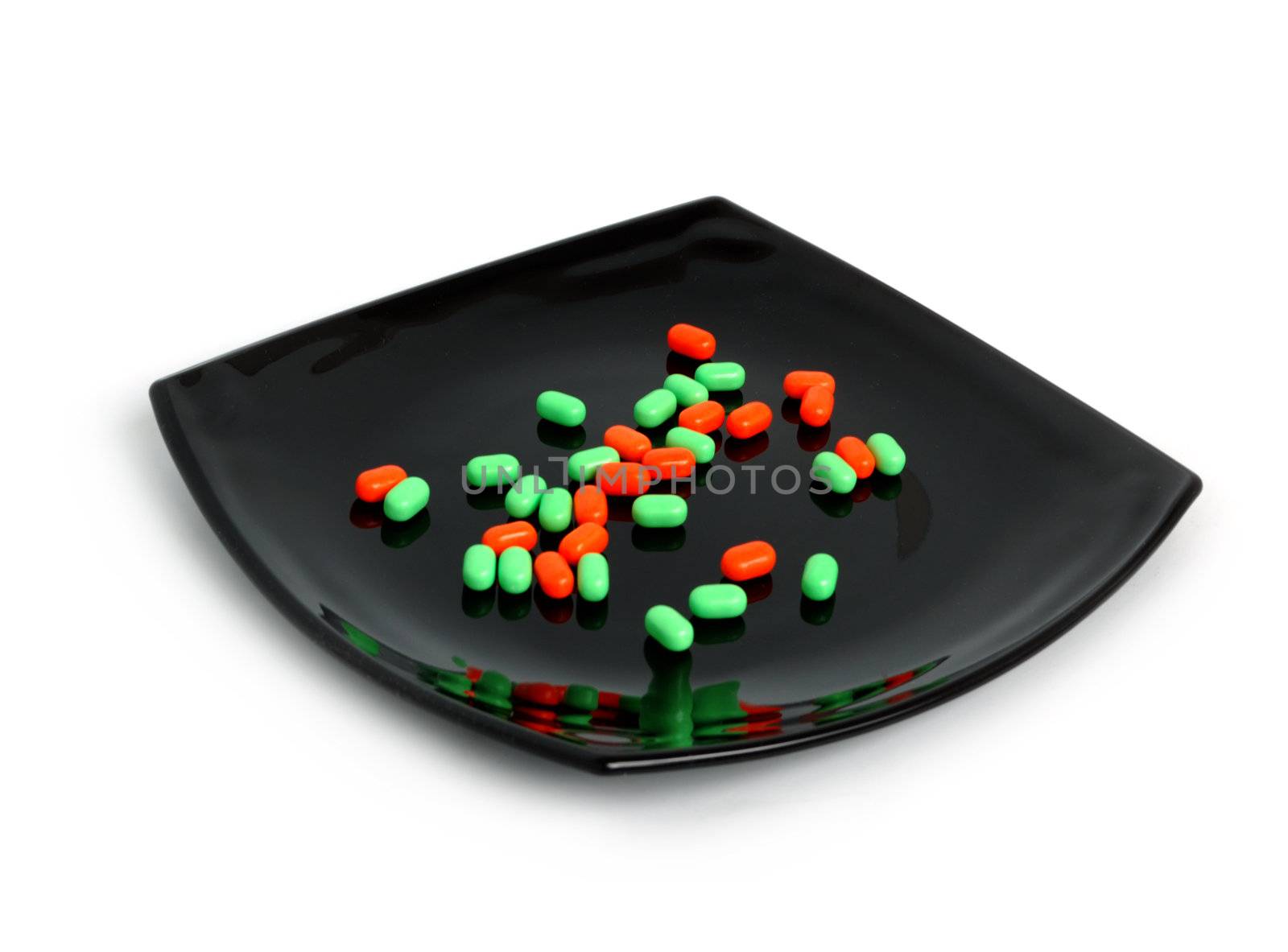 expensive chemical diet - colored pills on black asian plate