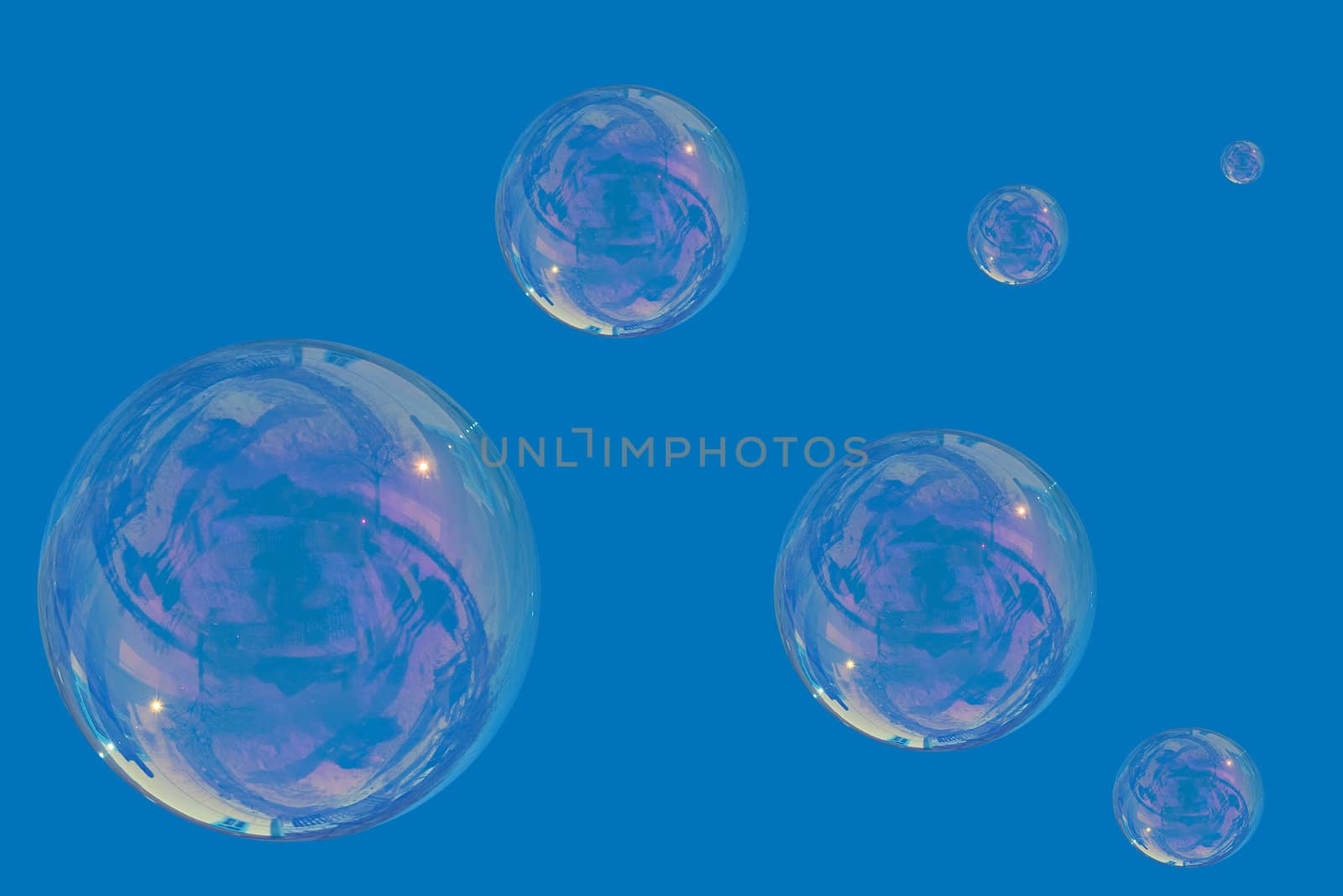 many soap bubbles over a blue sky background