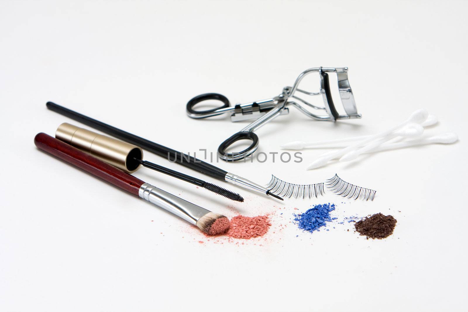Makeup set for the eyes with eyeshadows, brush, mascara, curler, q-tips and lashes, isolated