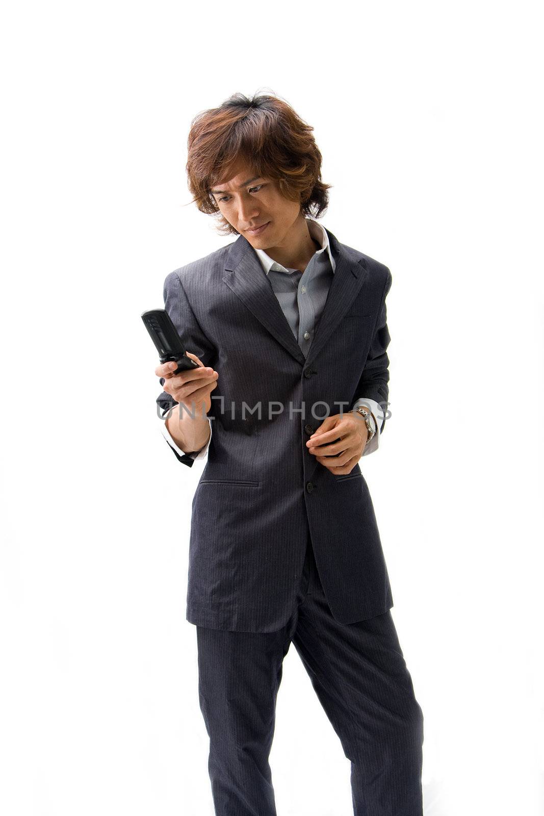 Young Asian business man with mobile phone texting, isolated
