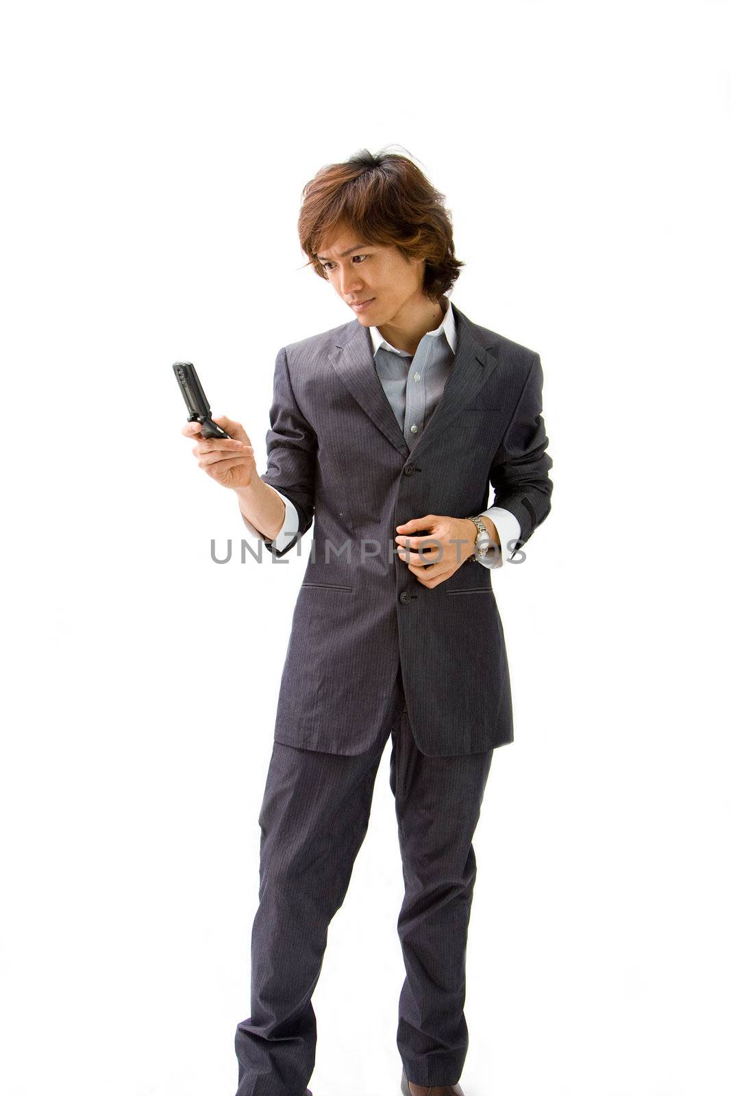 Young Asian business man with mobile phone texting, isolated
