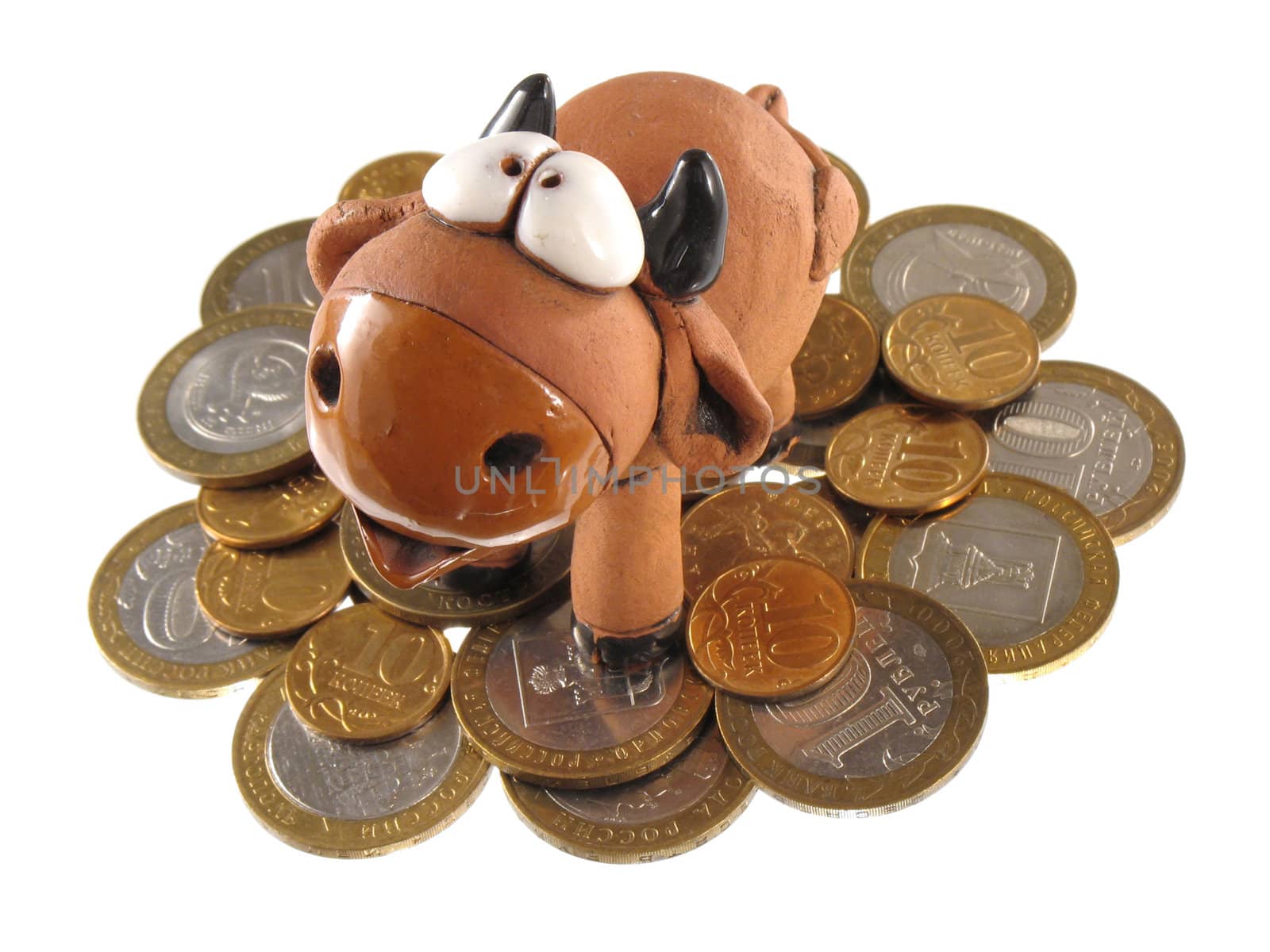 Ceramic bull or cow on the heap of coins, isolated.