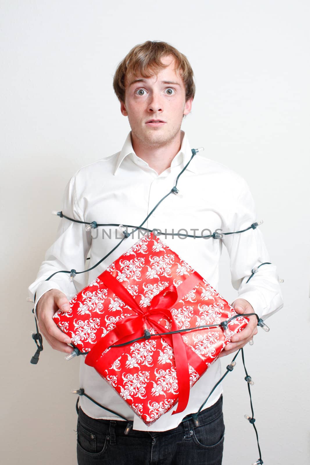 A depressed man holding a present