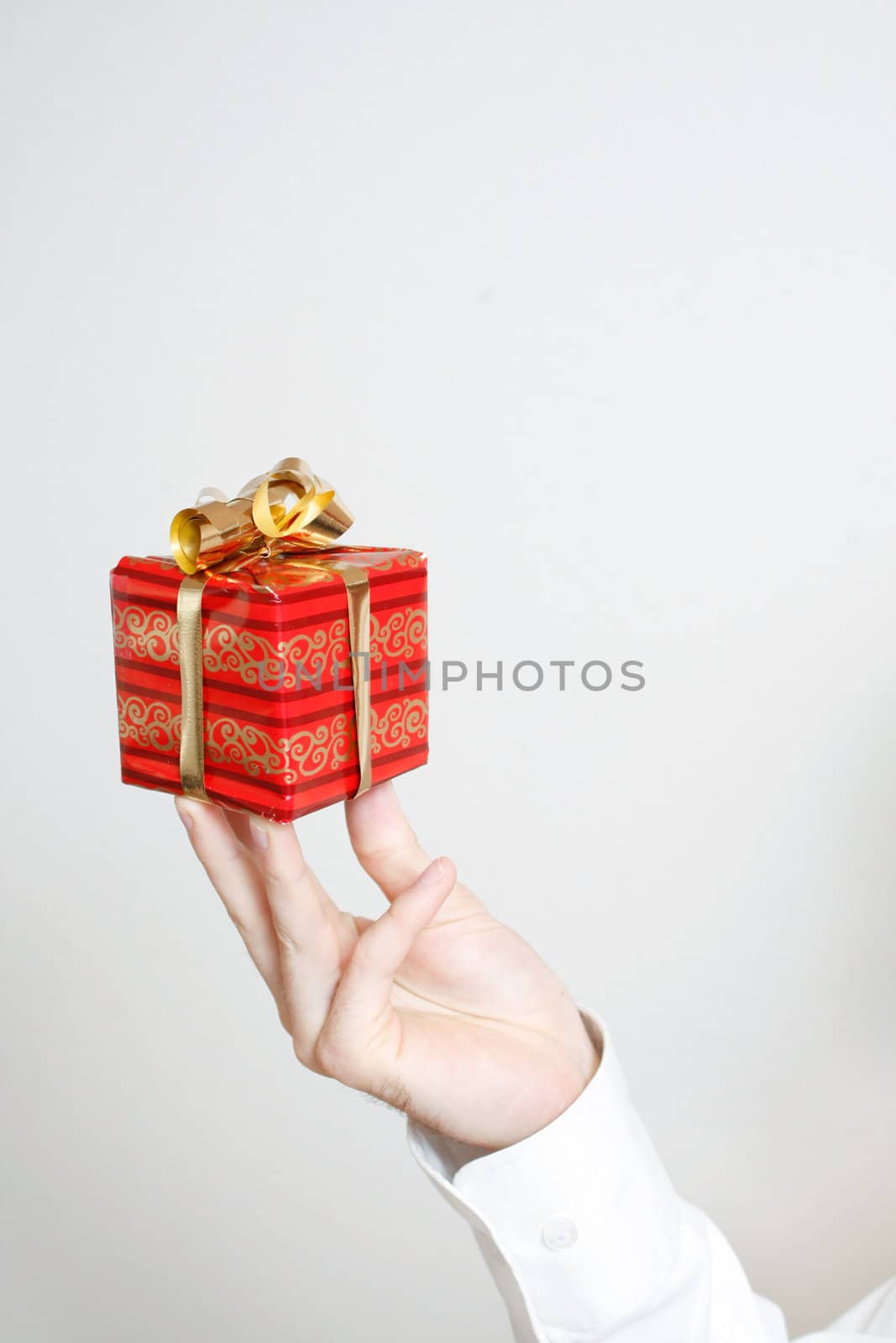 A hand holding a small present