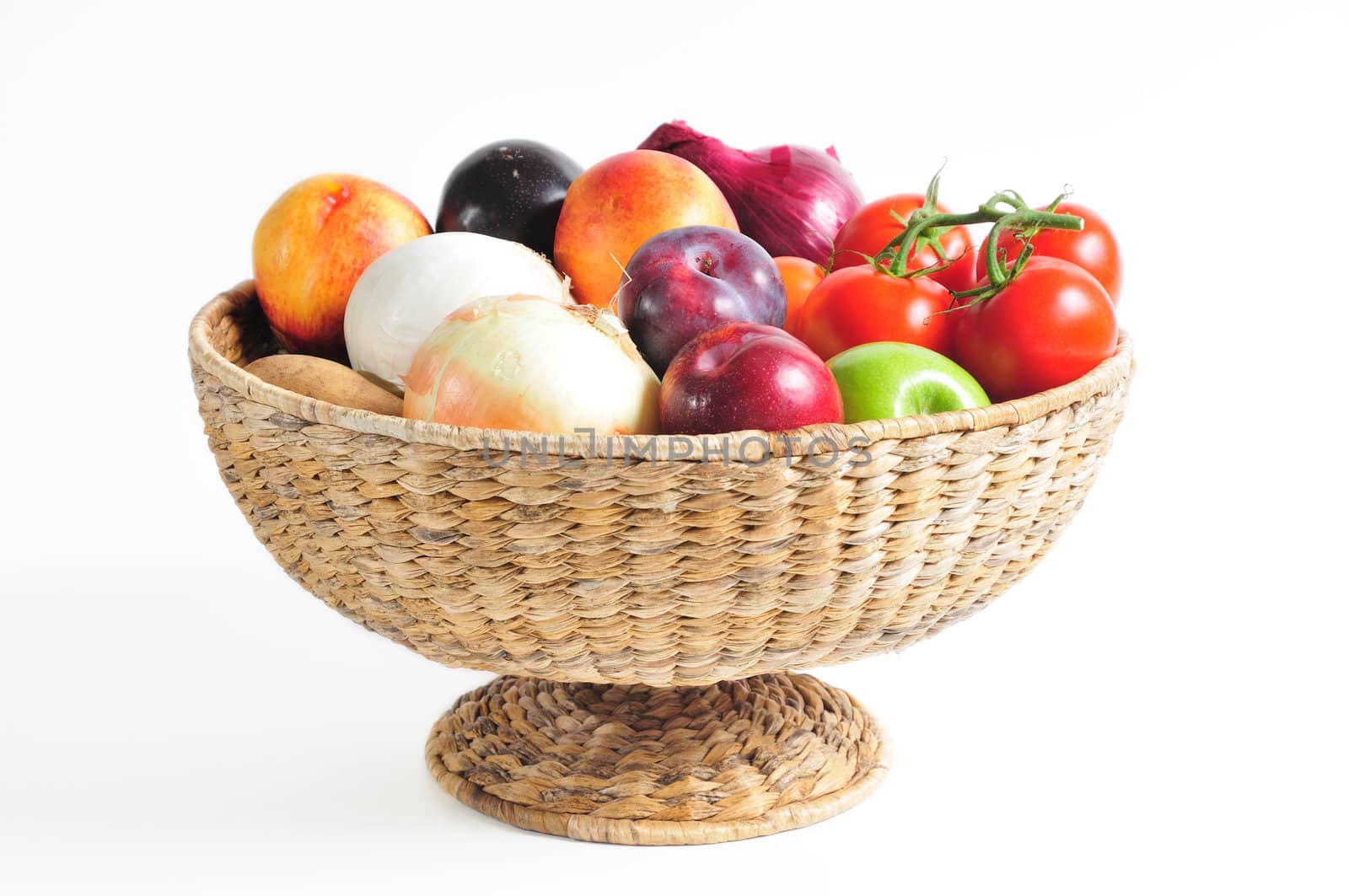 pedestal basket full of autumn fruits and vegetables