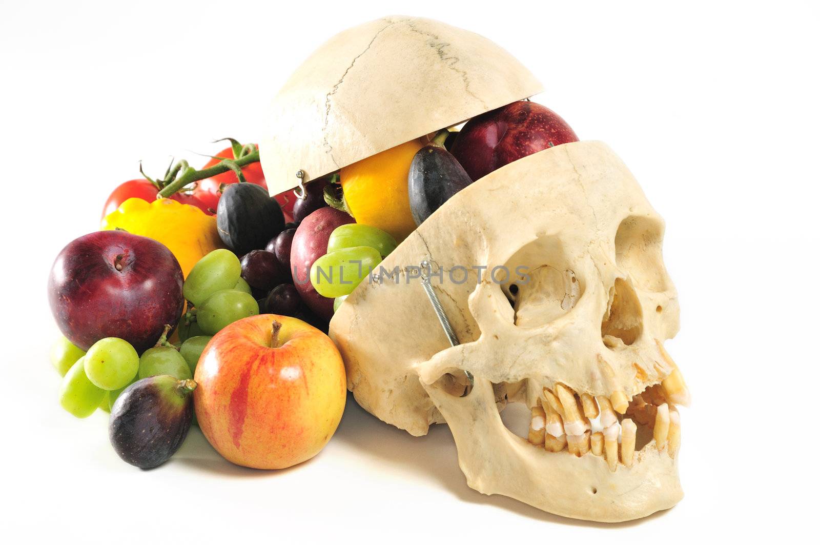 A human skull with skullcap overflowing with fruits and vegetables.