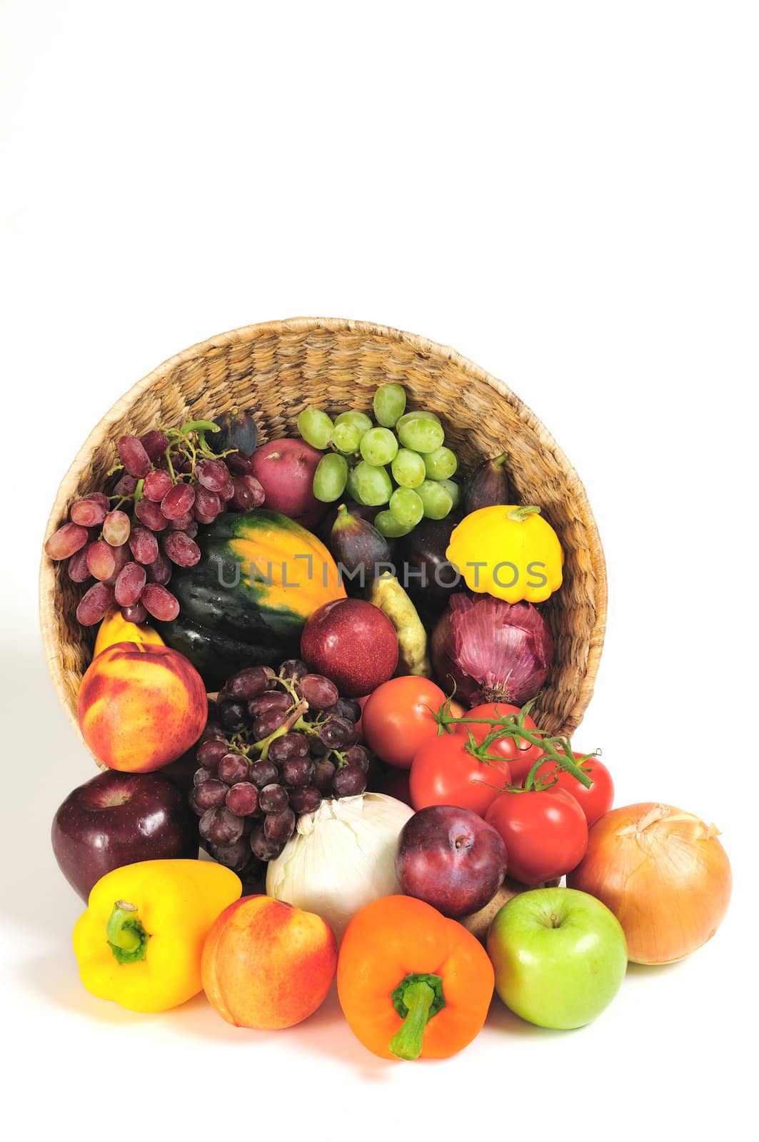 A rich bounty of autumn harvest foods spilling from a basket