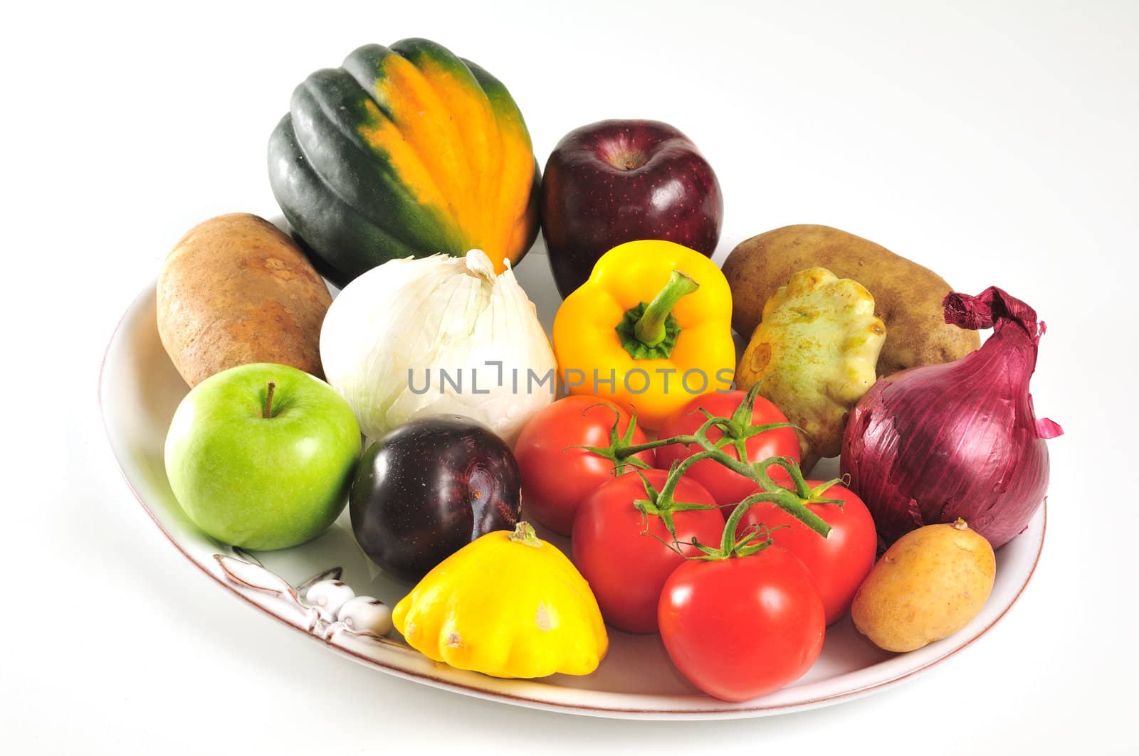 White porcelain platter full of autumn fruits and vegetables