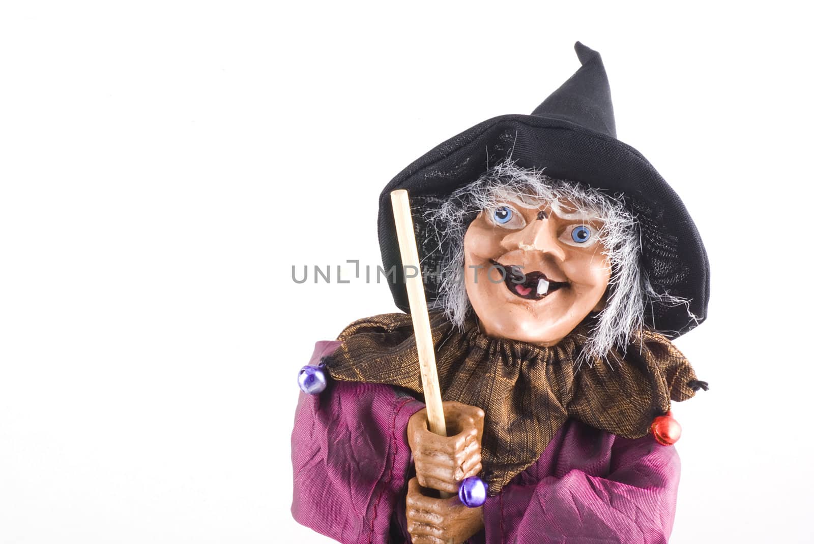 Portrait of a witch doll with copyspace; isolated on white.