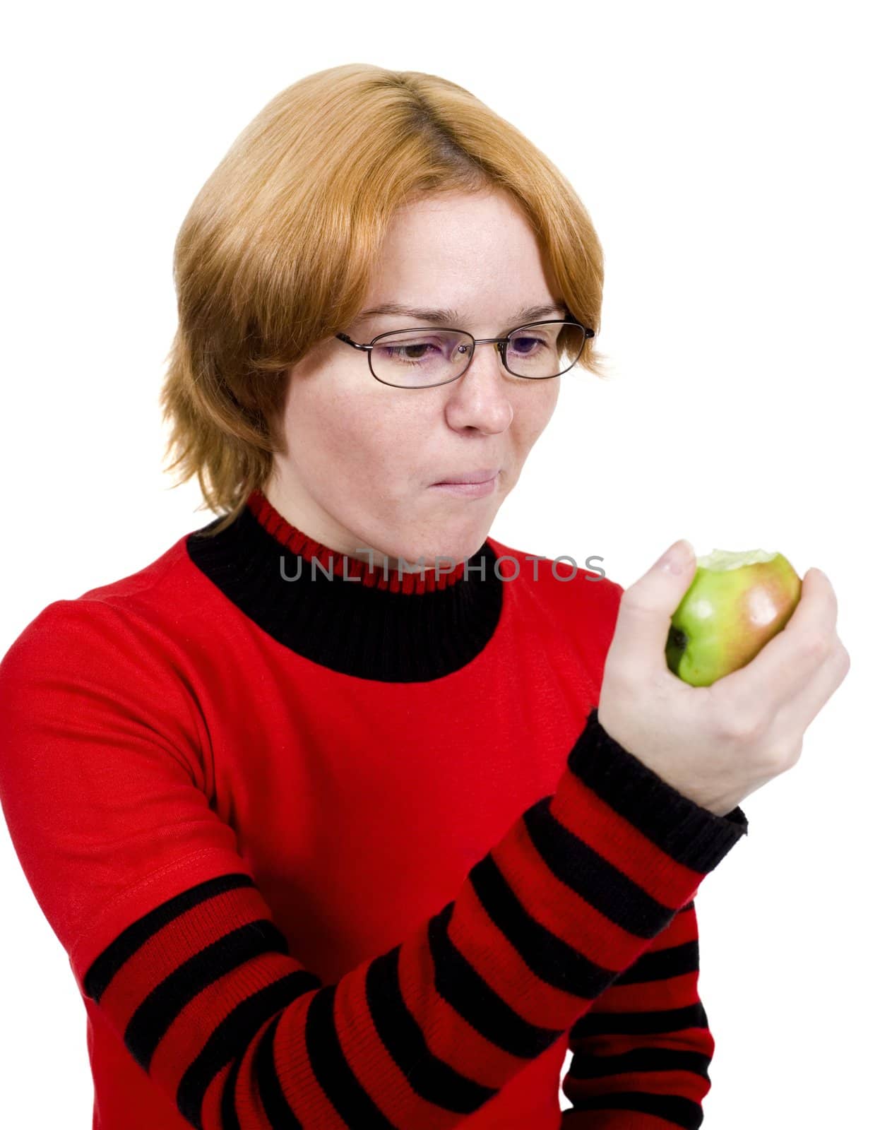 The girl in a red sweater eats an apple