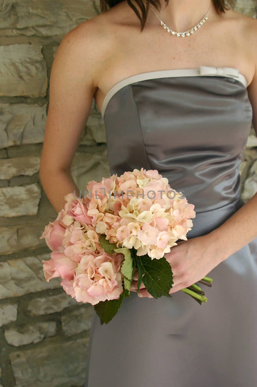A chic image of a bridesmaid with her bouquet