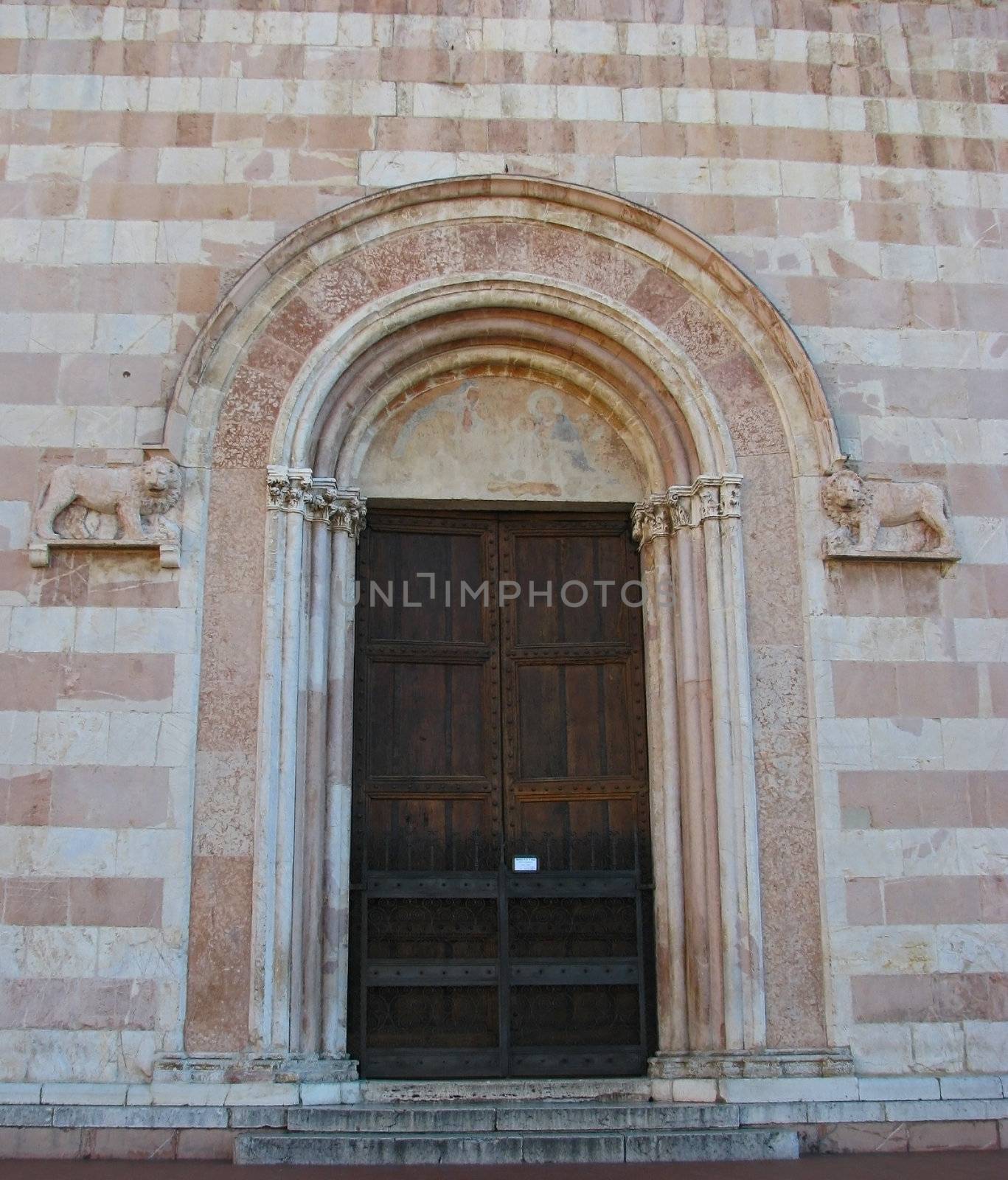 The ancient doors of St. Clare Basilica in Assisi, Italy
