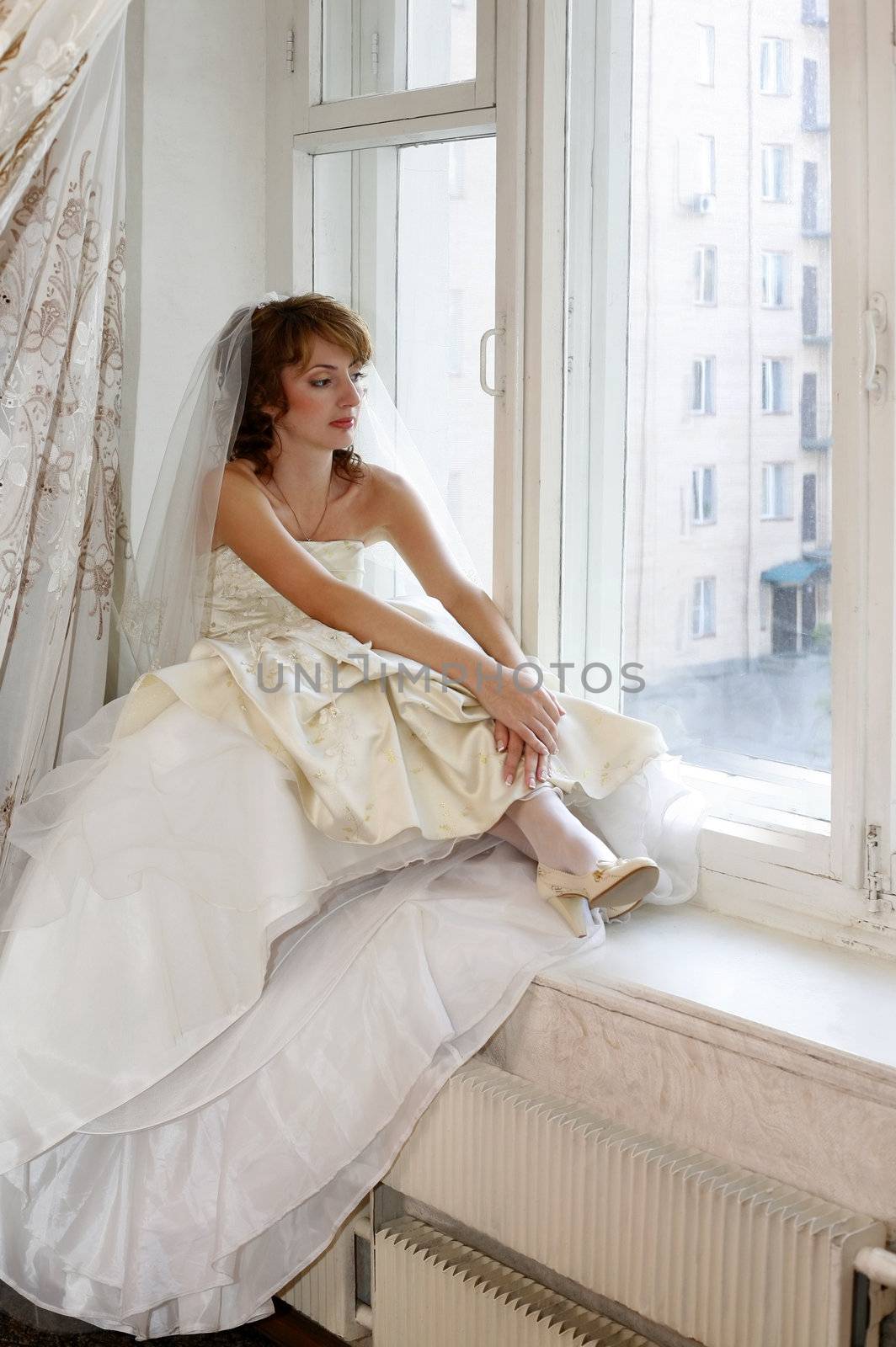 The beautiful thoughtful bride in an interior