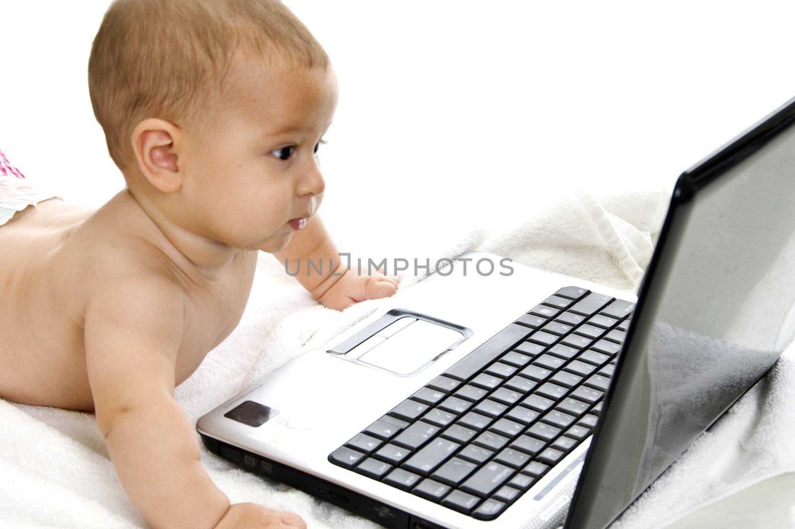 cute baby boy showing curiosity about laptop with white background