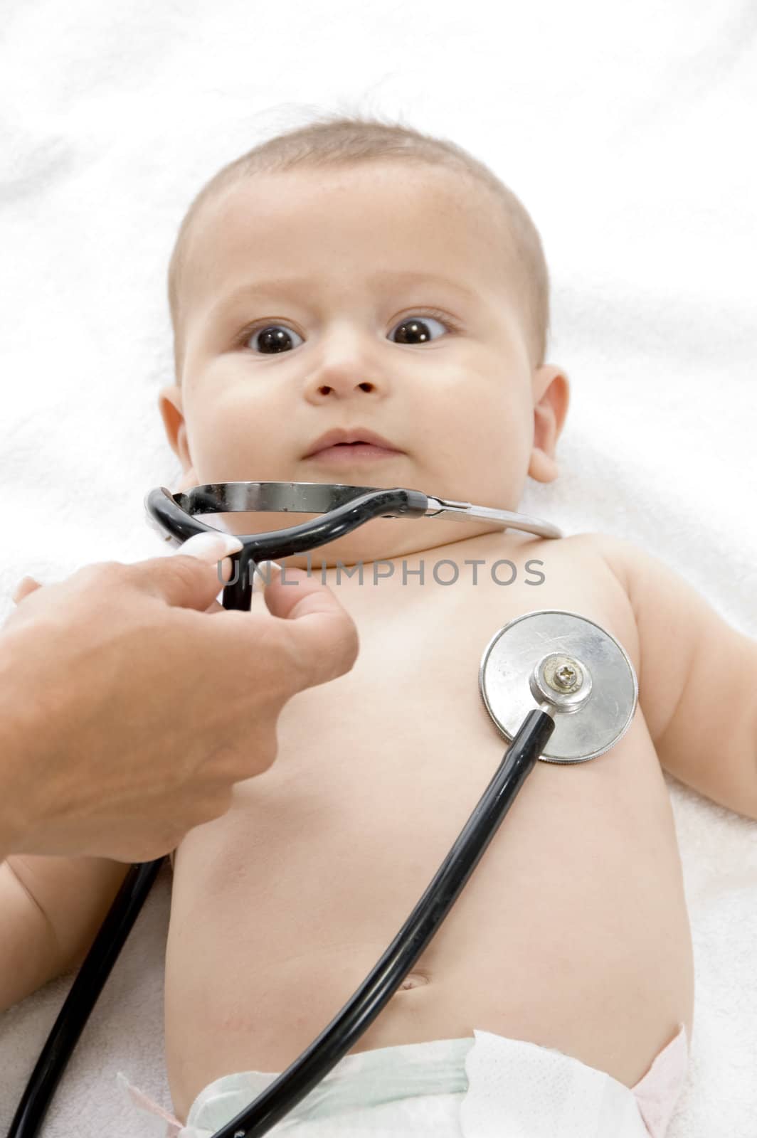 doctor's hand examine of young baby and baby looking to his