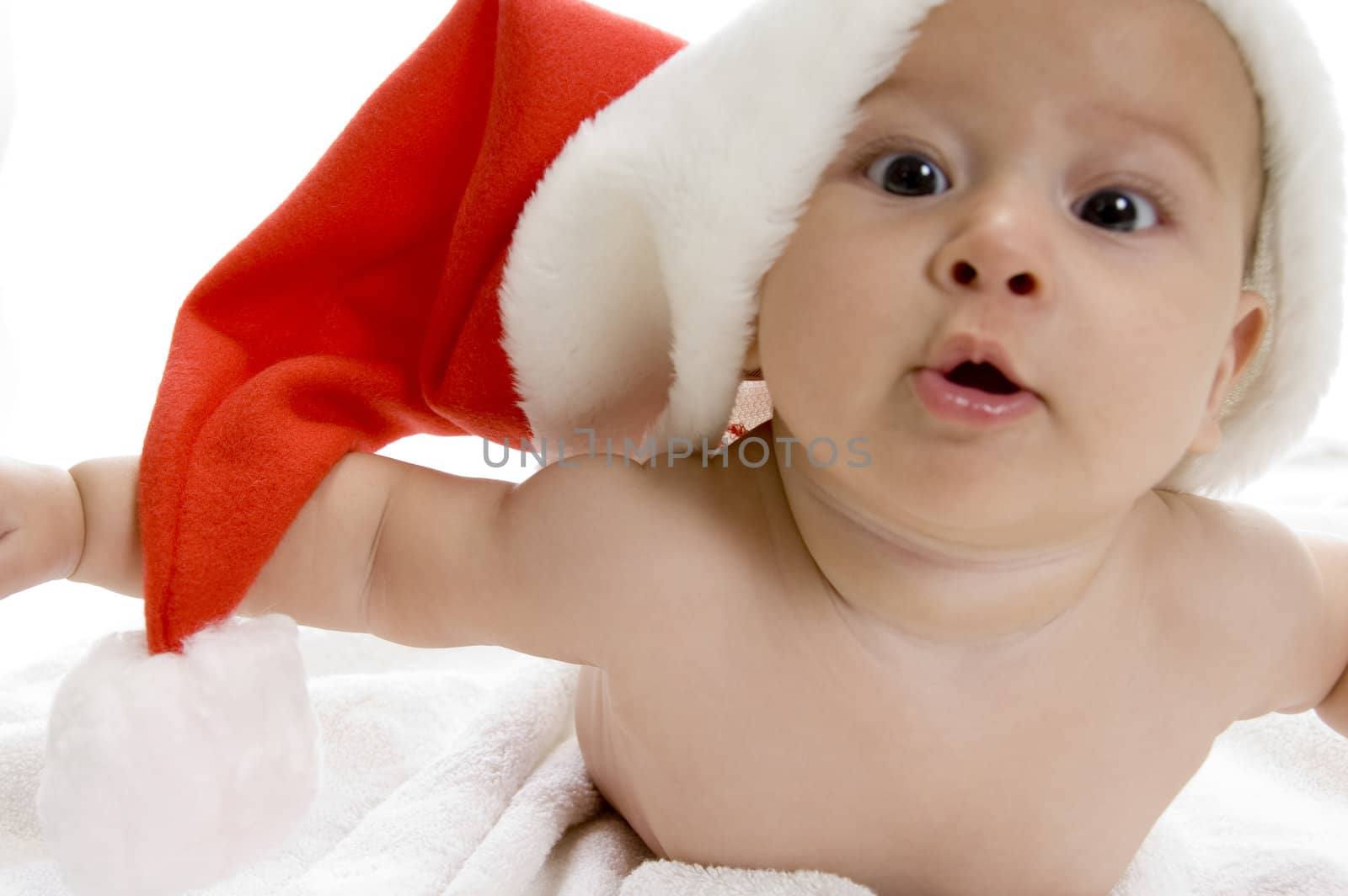 young cute smiling baby boy with red santa cap