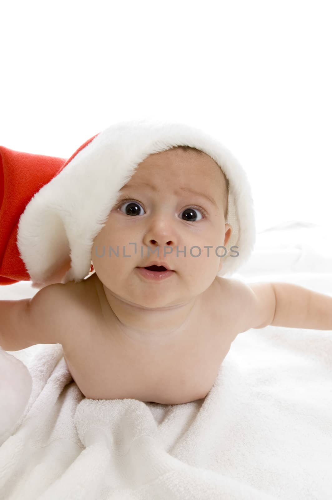 cute baby lying with santa cap against white background