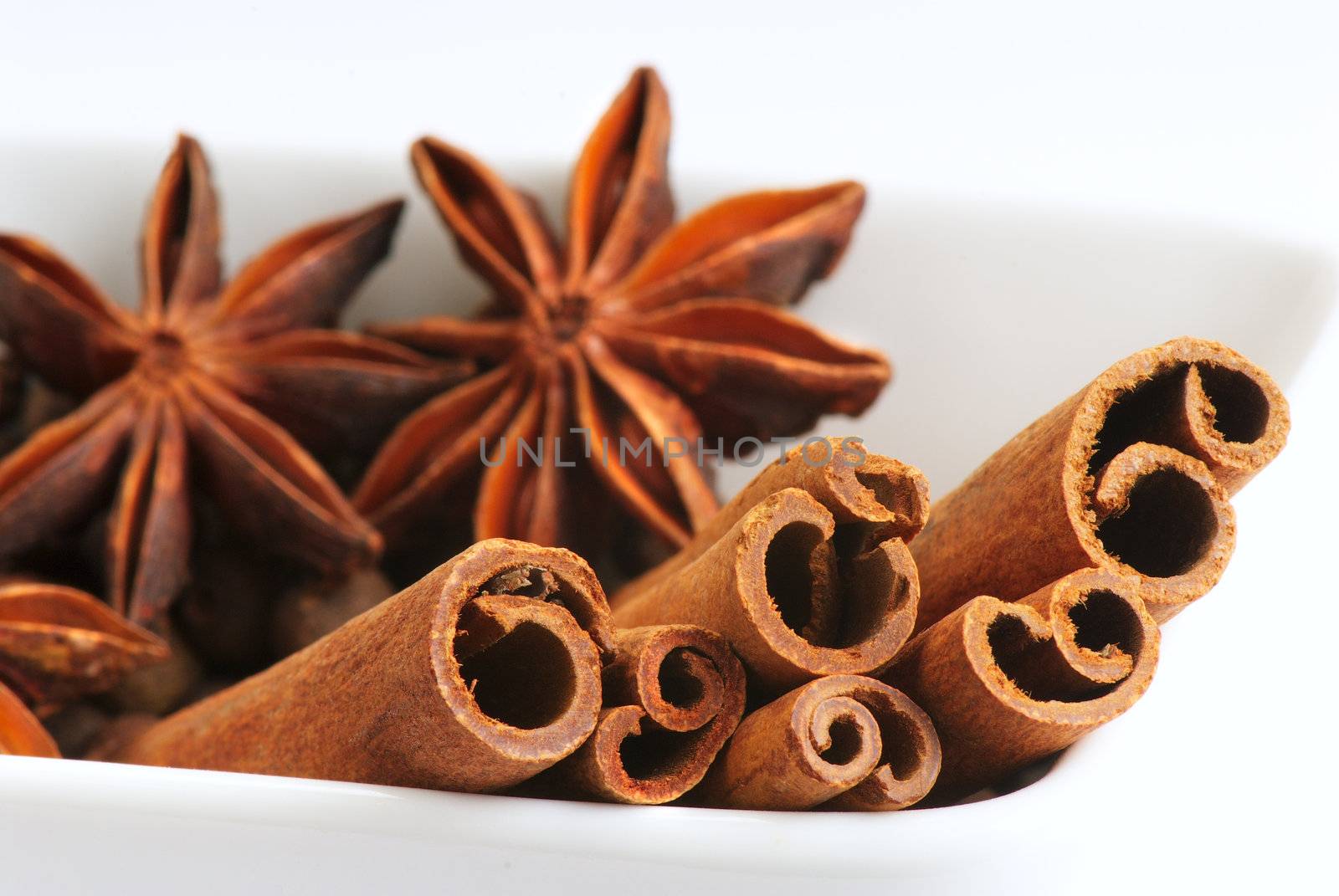 Star anise and cinnamon sticks, on a porcelain ware