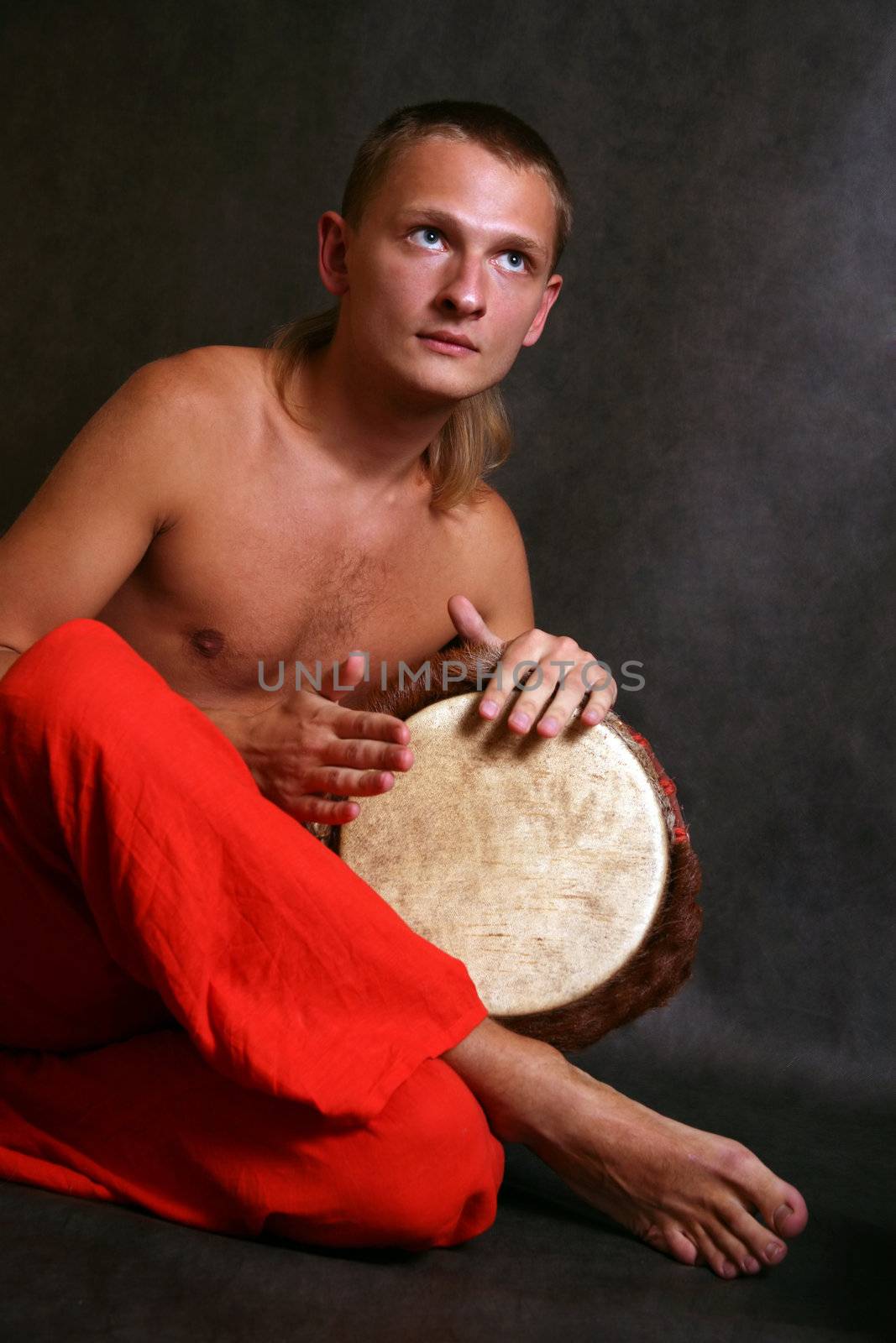Man playing the nigerian drum in studio