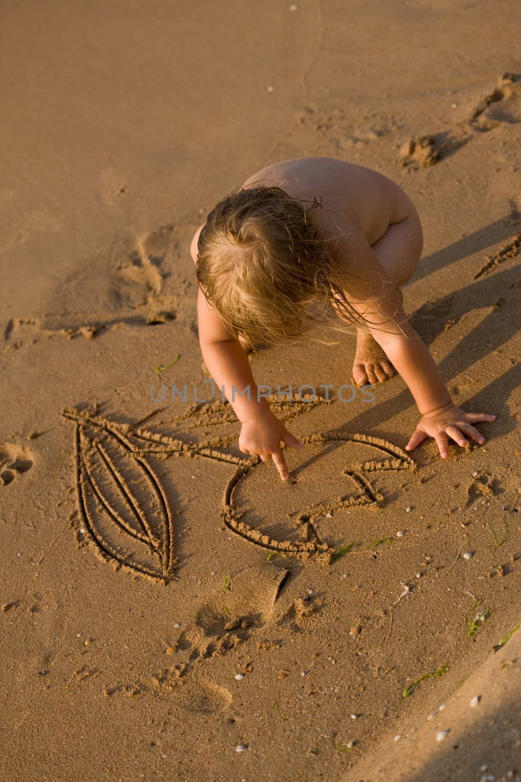 people series: little girl draw on the sand