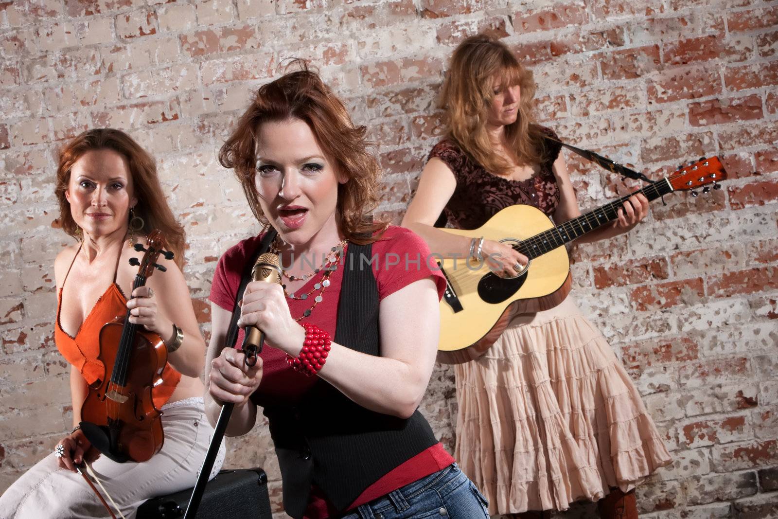 Country and western girl band performing in stylish clothing 