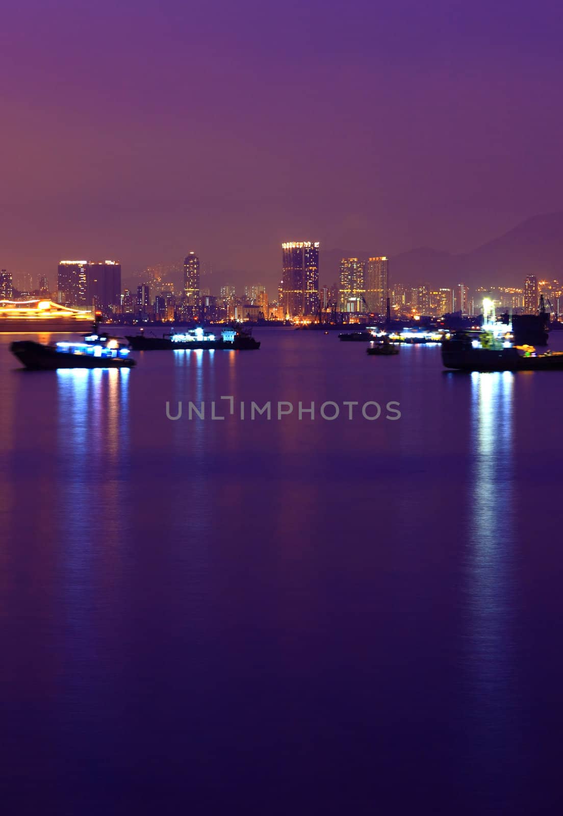 Ship in harbour at night with reflection