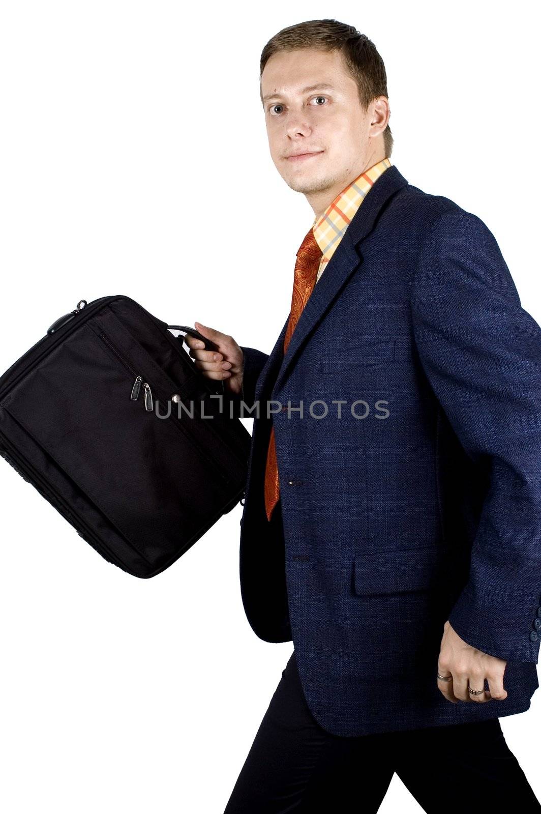 Young, successful and happy businessman walking with briefcase.