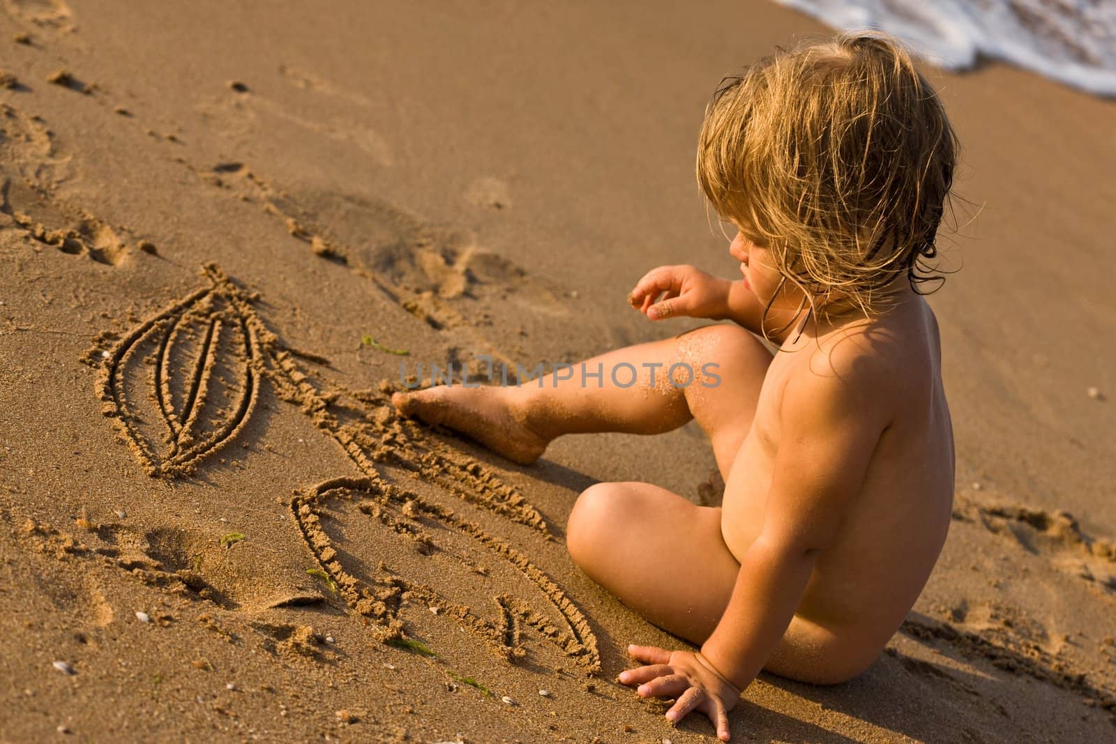 people series: little girl draw on the sand