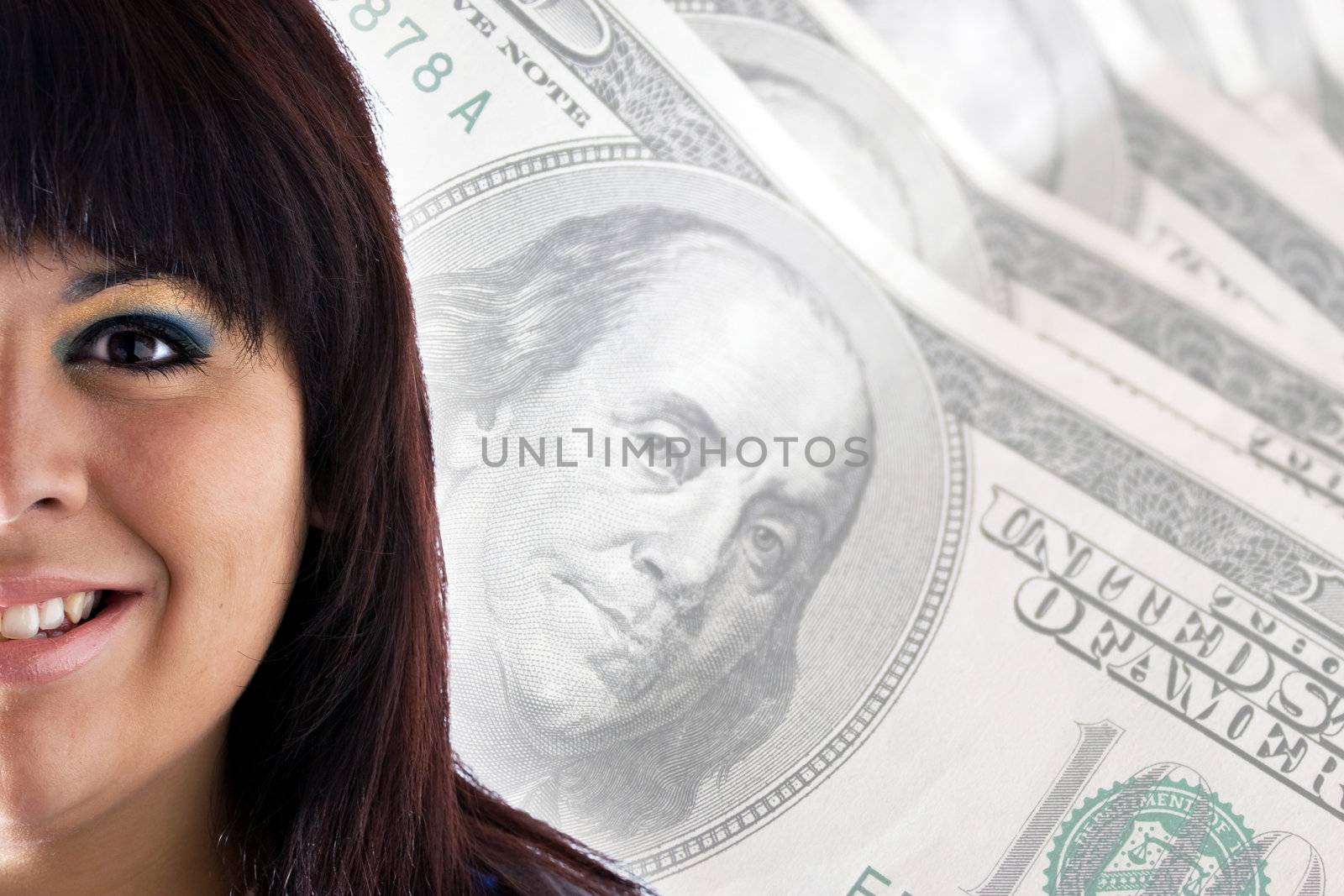 A rich or successful smiling woman in front of a money background with copy space for your text.