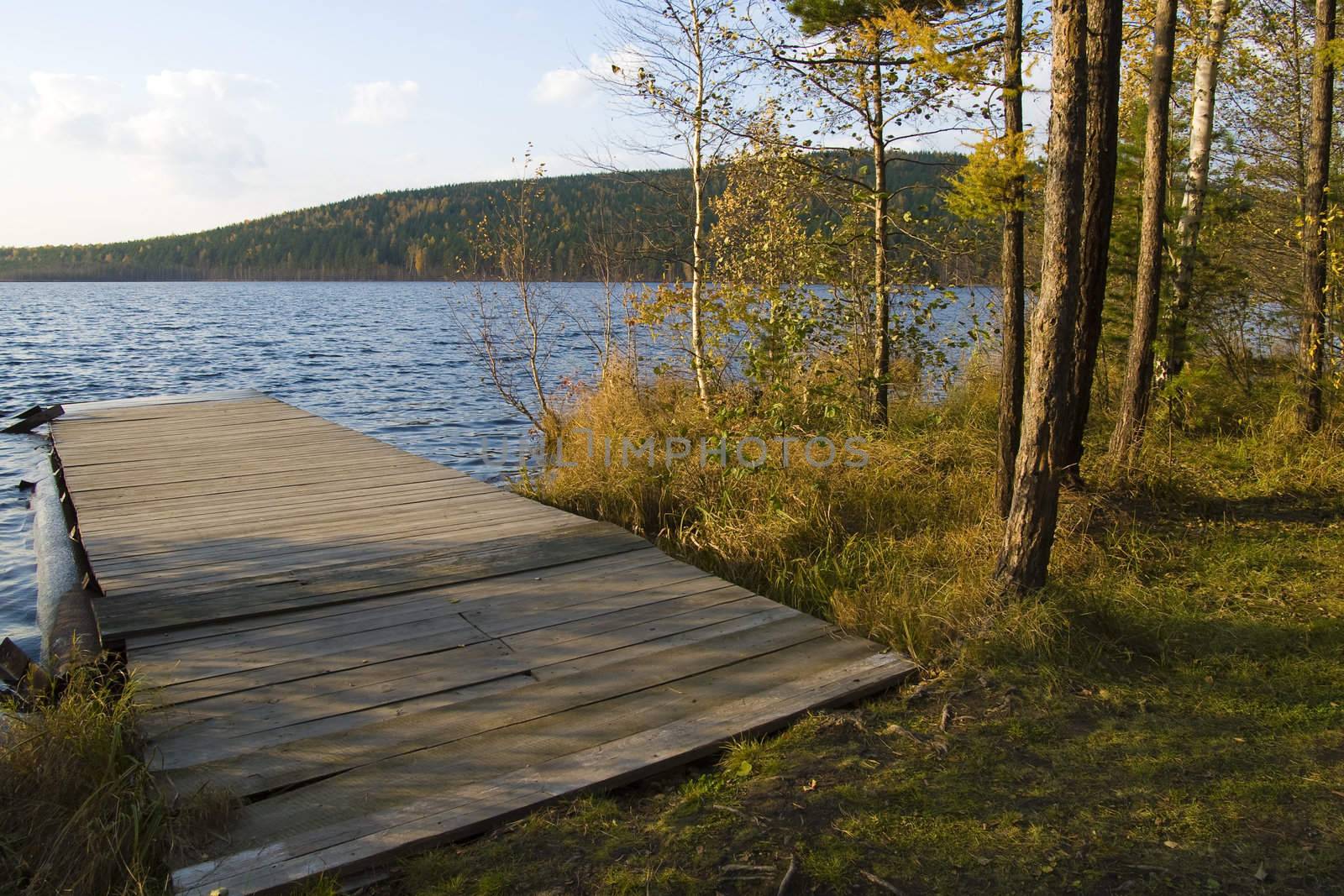 Old wooden moorage on a lake shot at sunset light