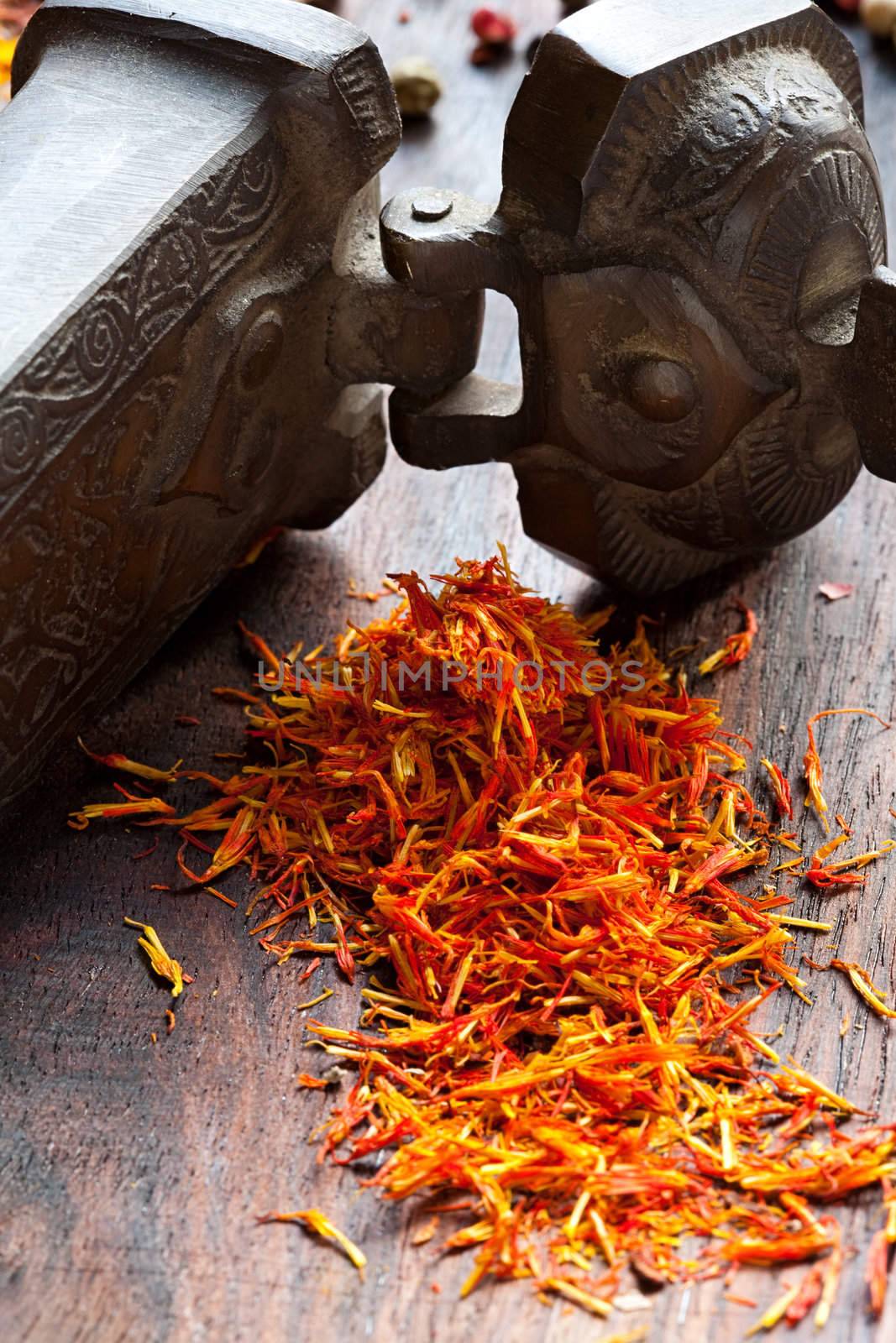 Dried petal of saffron on oriental cast-iron tin