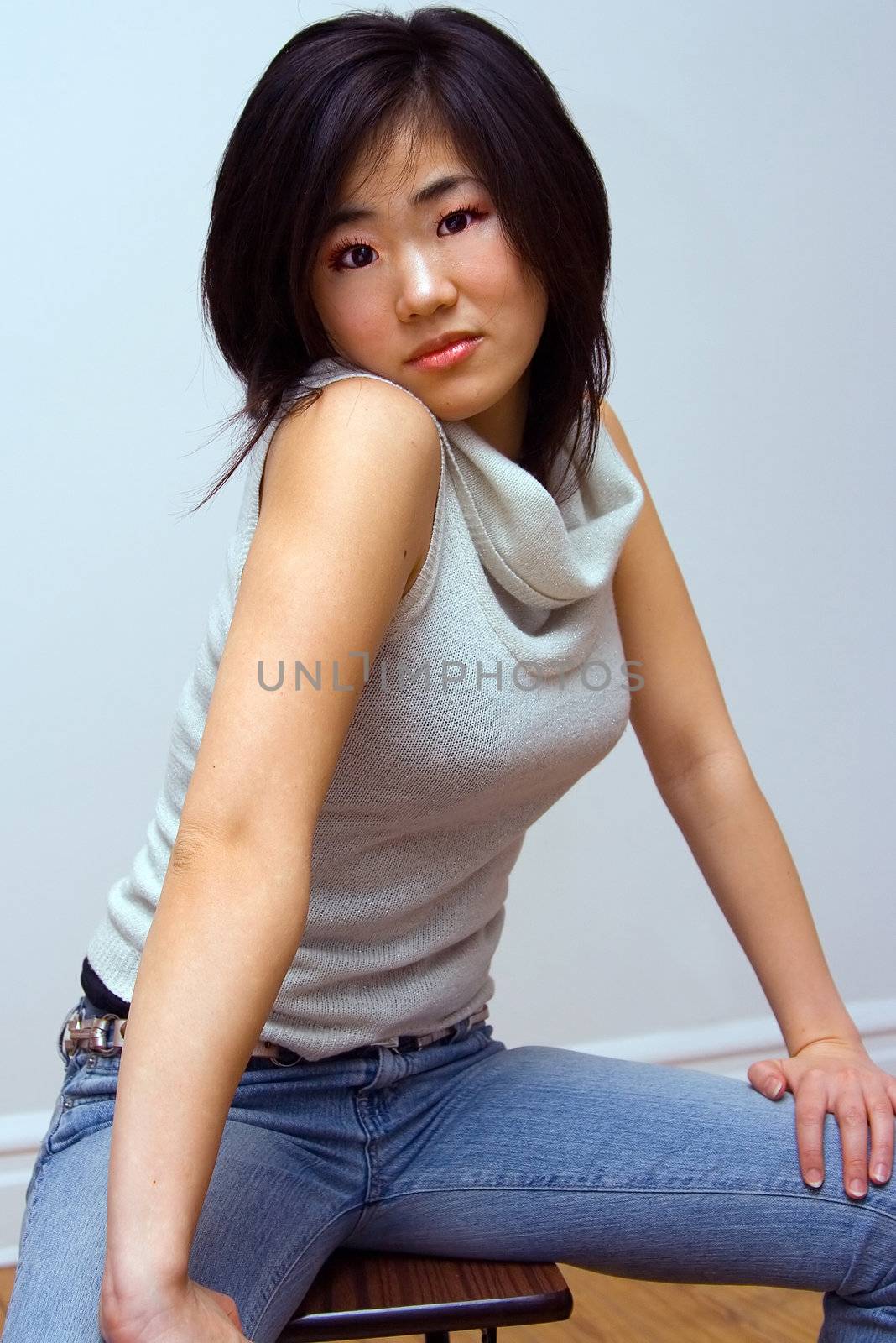 Beautiful Oriental woman with an attitude in a white collared shirt