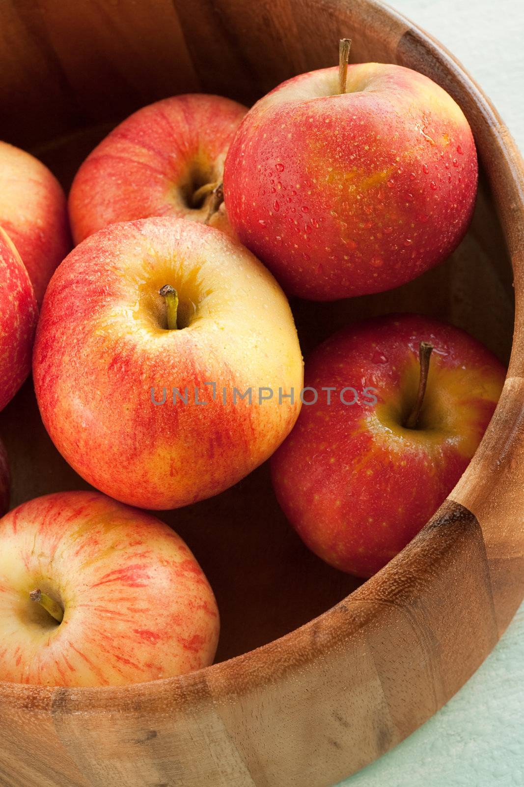 Several red ripe apple on wooden bucket