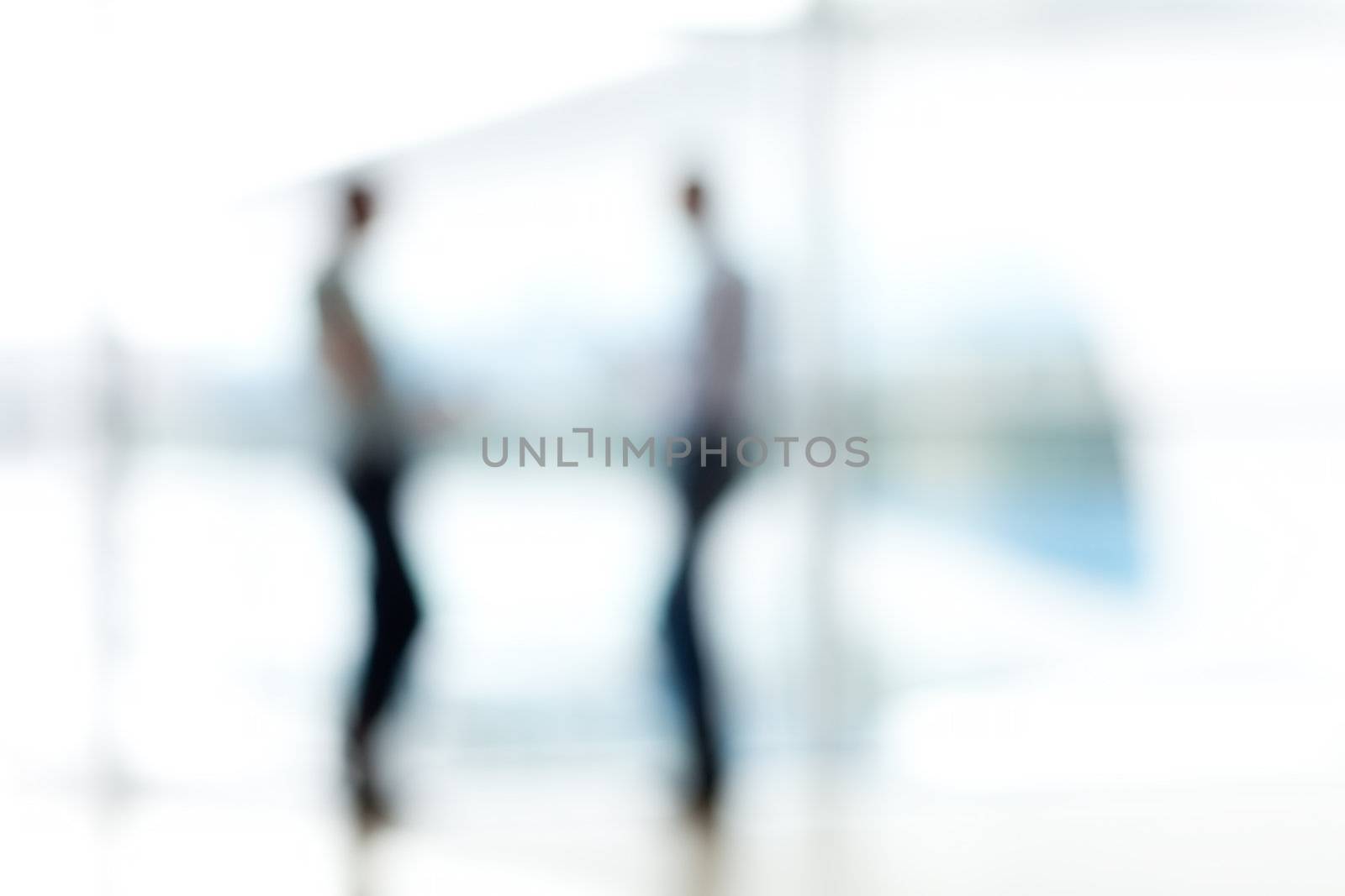 Two mans silhouette in hall of office building
