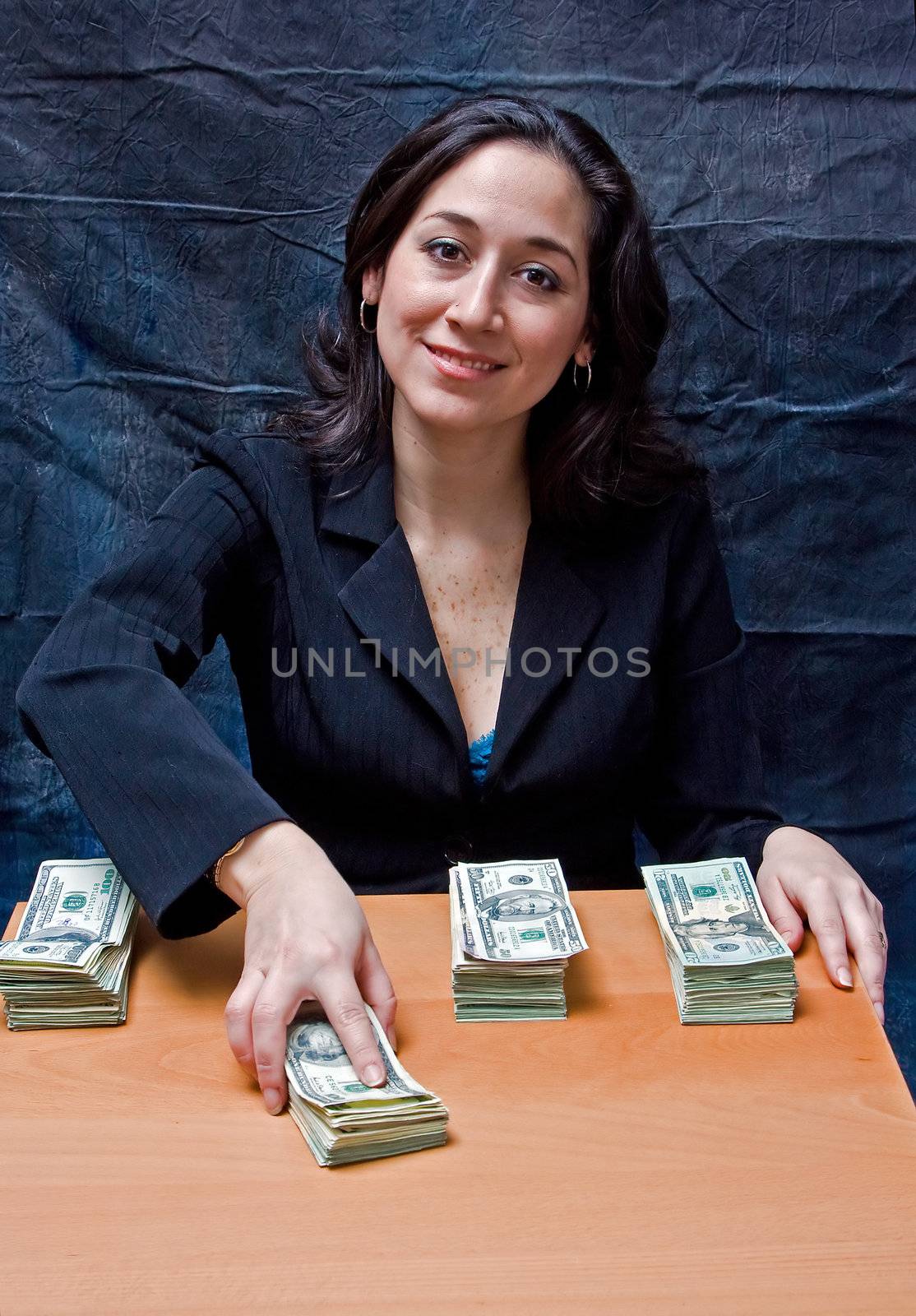 Happy smiling business woman paying ourt money isolated on a dark background
