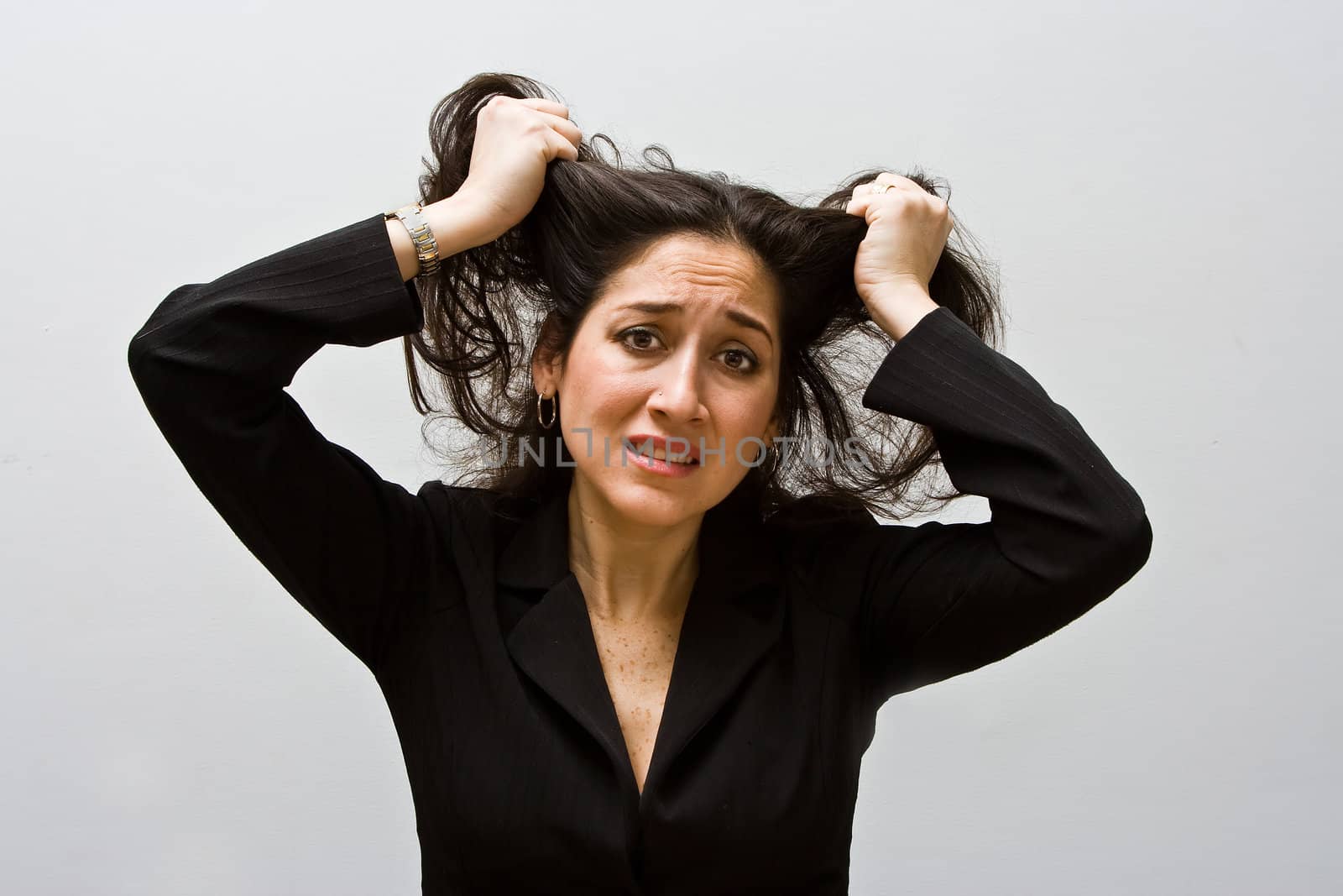 Stressed and worried business woman, grabbing and pulling her hair, isolated on a white background