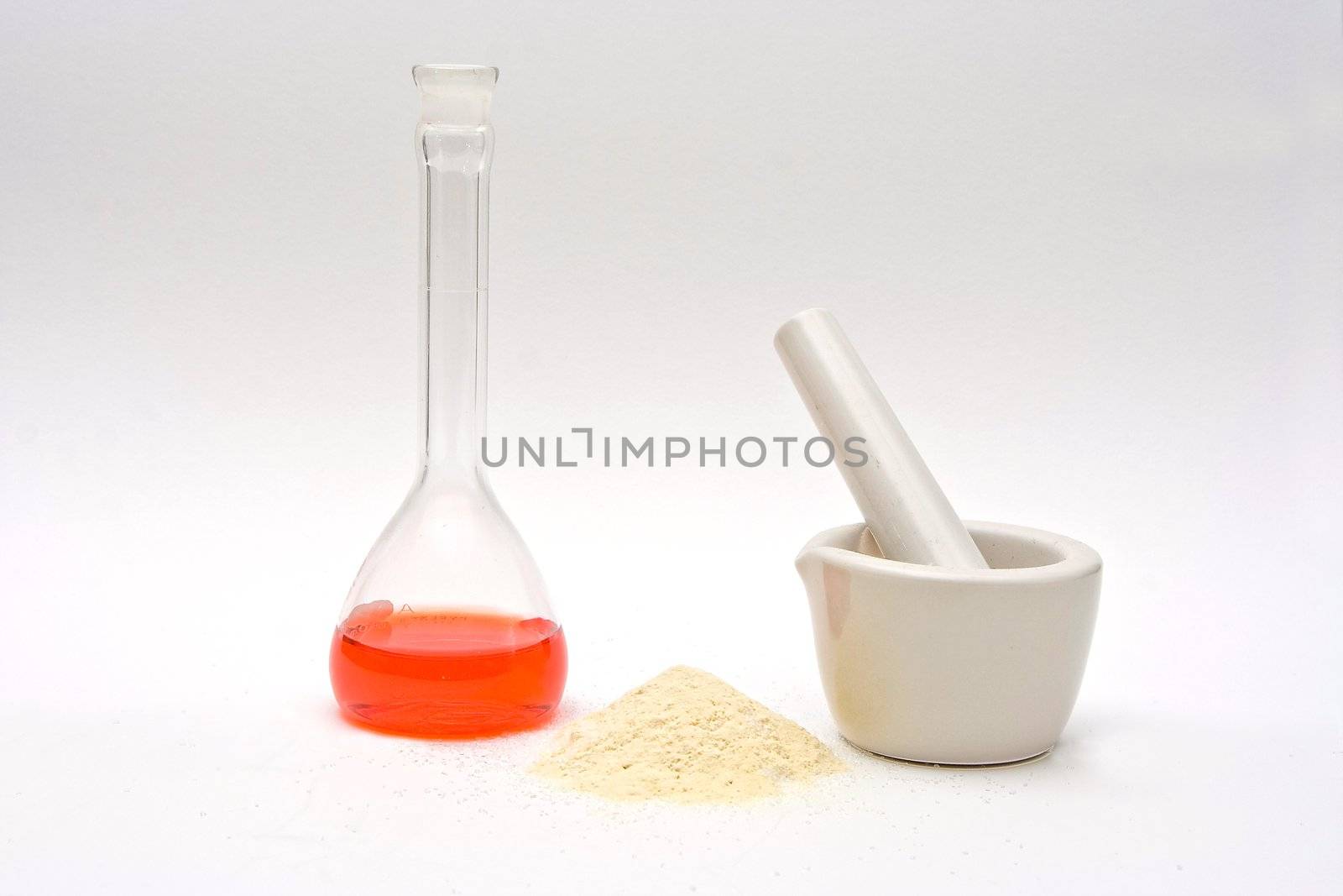 A red liquid in a flask with a powder in front and a white mortar on a white background