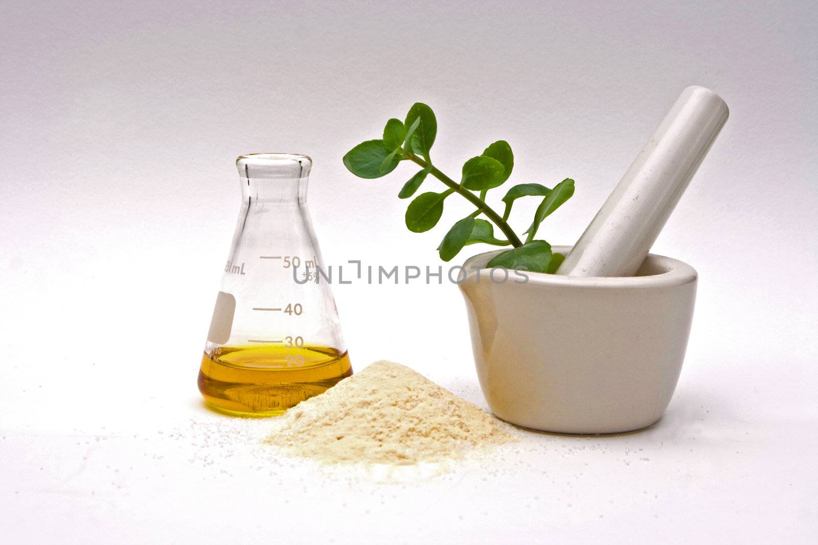 A yellow liquid in a flask with a powder in front and a white mortar with asome leaves in it on a white background