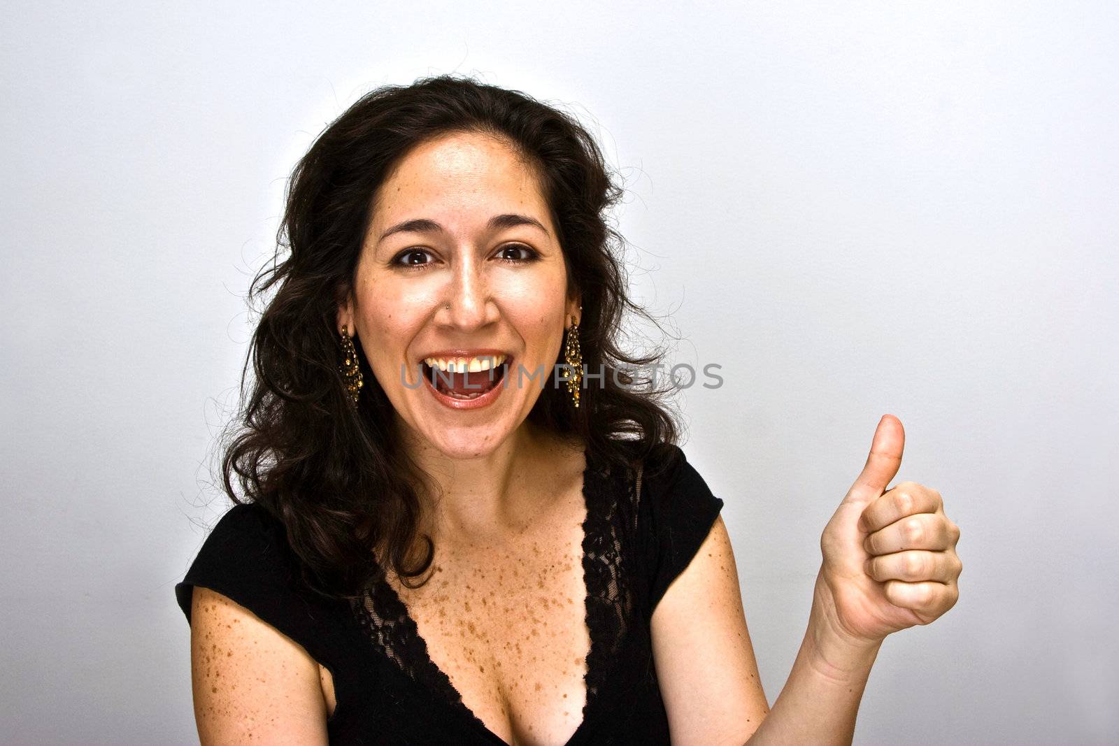 Woman who just came up with a great idea. Pointing up her thumb and mouth open of satisfaction, on a white beackgrounds.