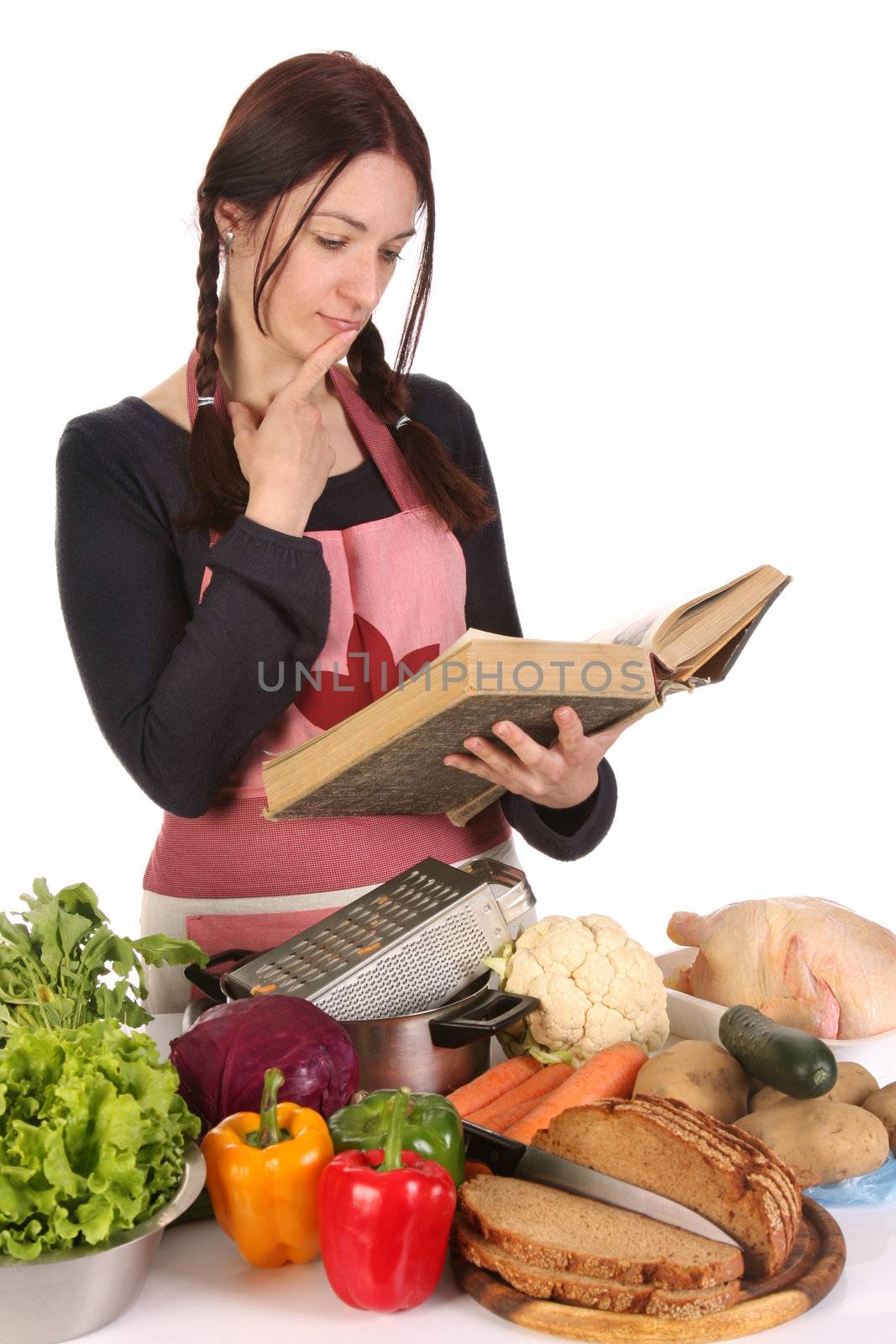 beautiful housewife thinking with a book recipe