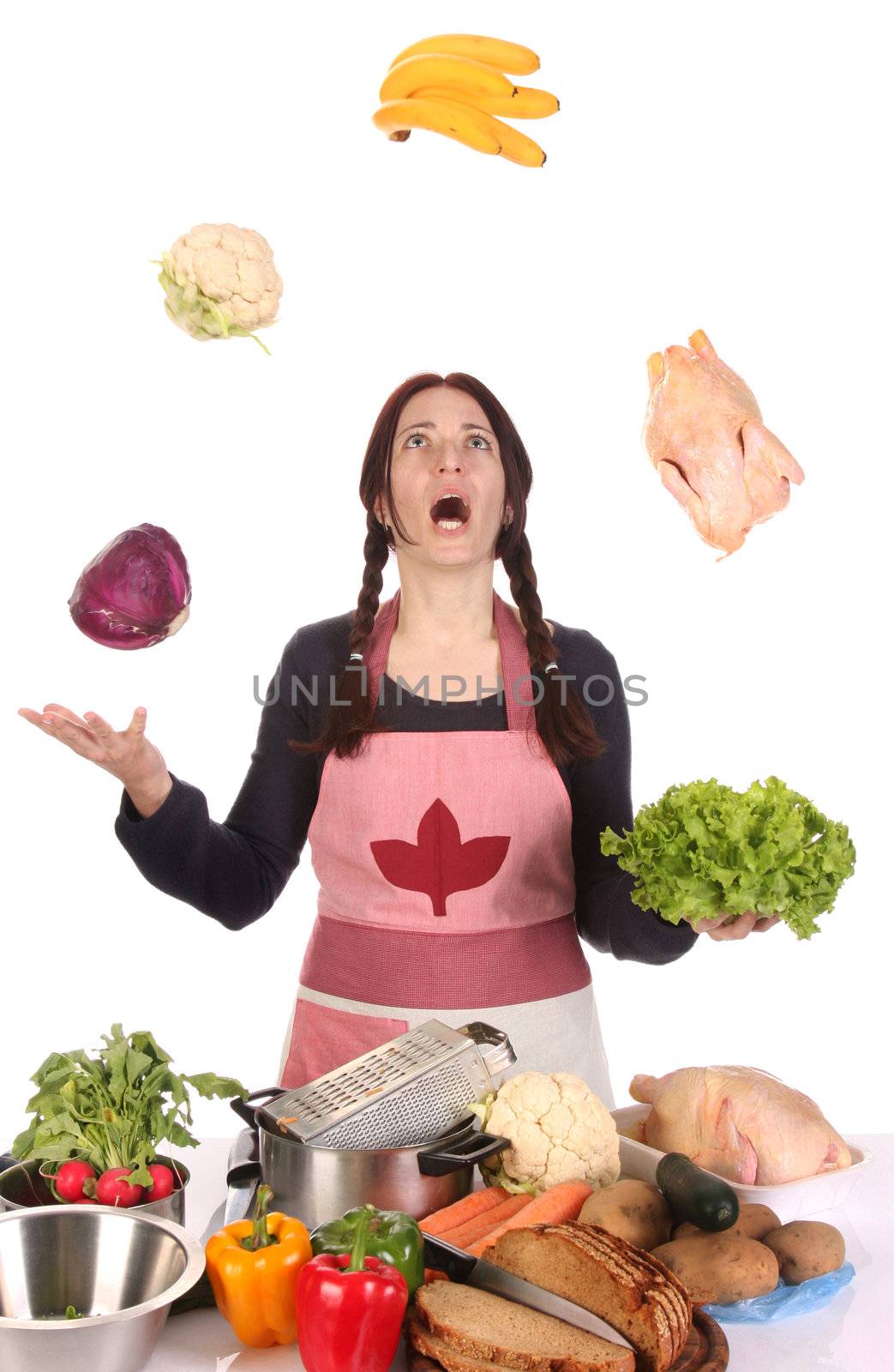 beautiful housewife juggling with fruit and vegetables