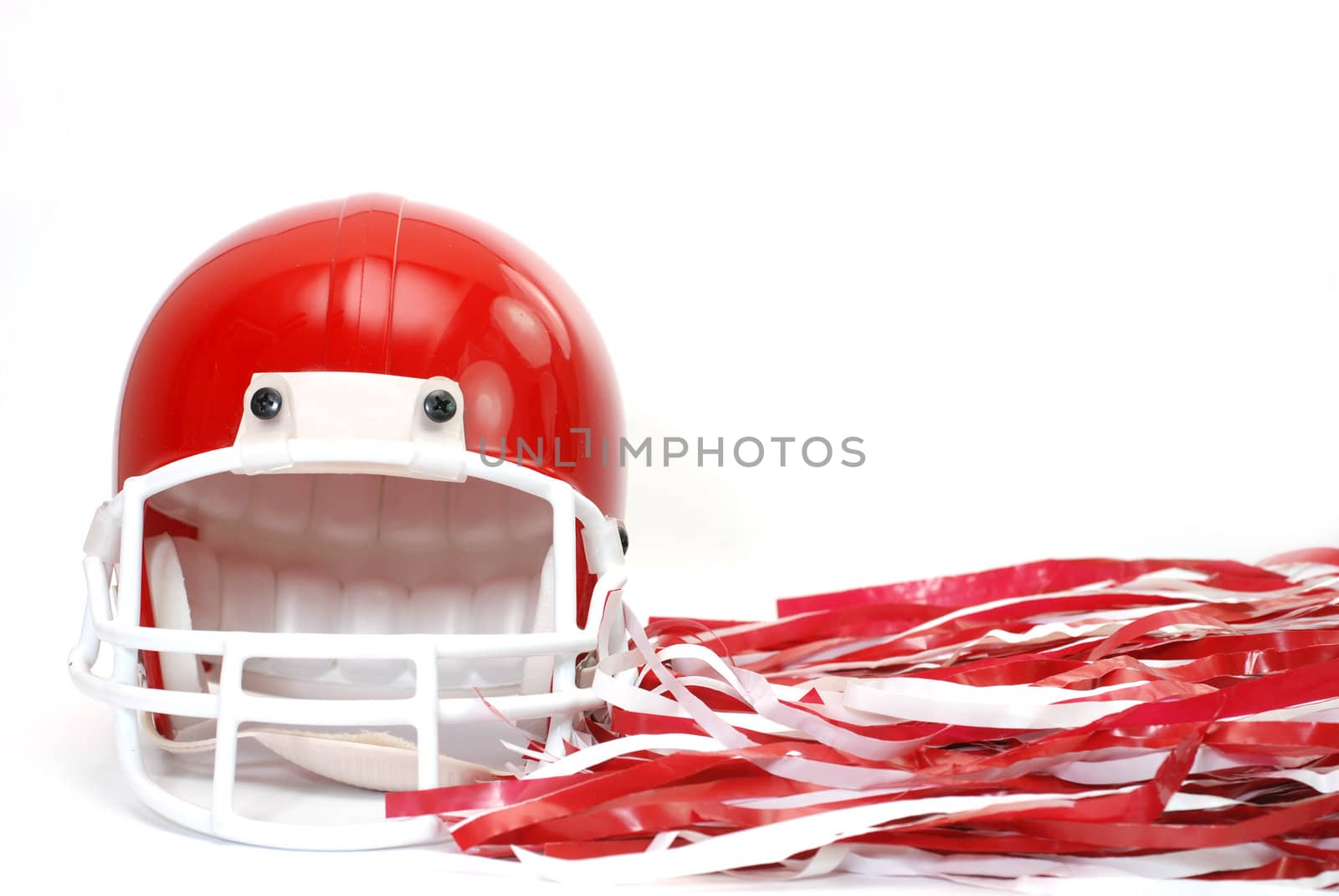 Red football helmet and pom poms isolated on white background.
