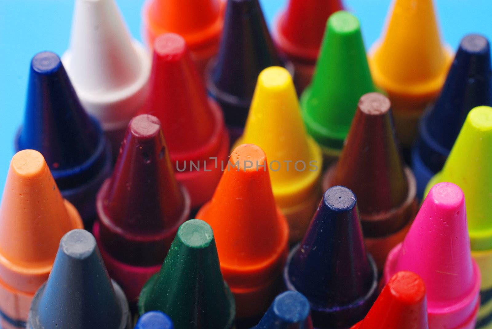 Closeup of assorted crayons with focus on orange.