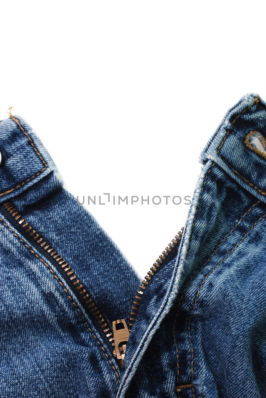 Closeup of zipper in blue jeans isolated on white background.